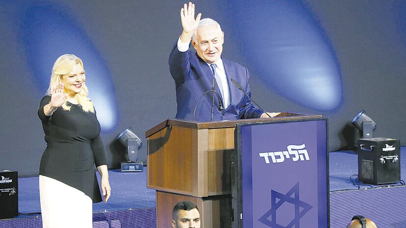 Netanyahu, junto a su esposa Sara, saluda a sus seguidores en el bunker de Likud en Tel Aviv.