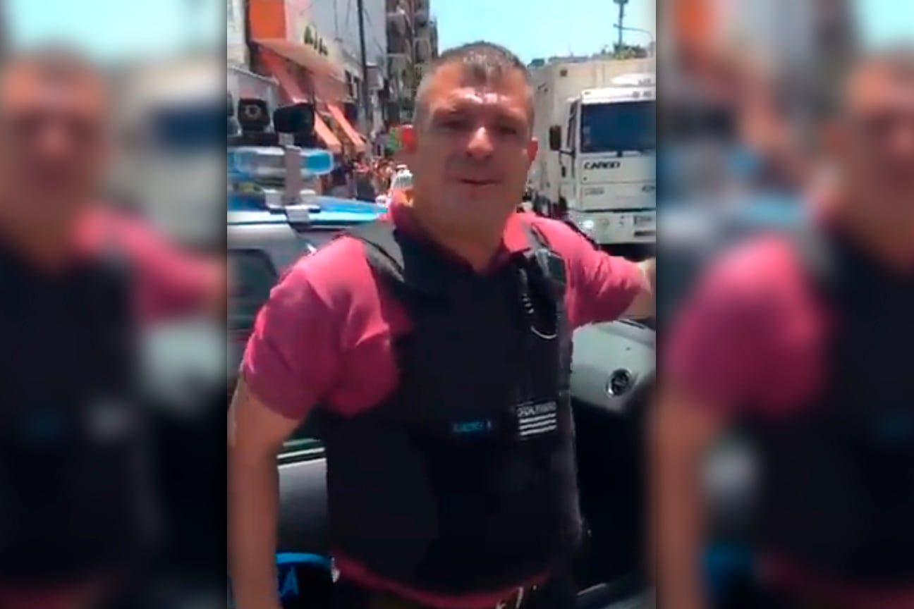 El policía en el momento de la agresión al vecino tras la detención del vendedor ambulante en Flores.