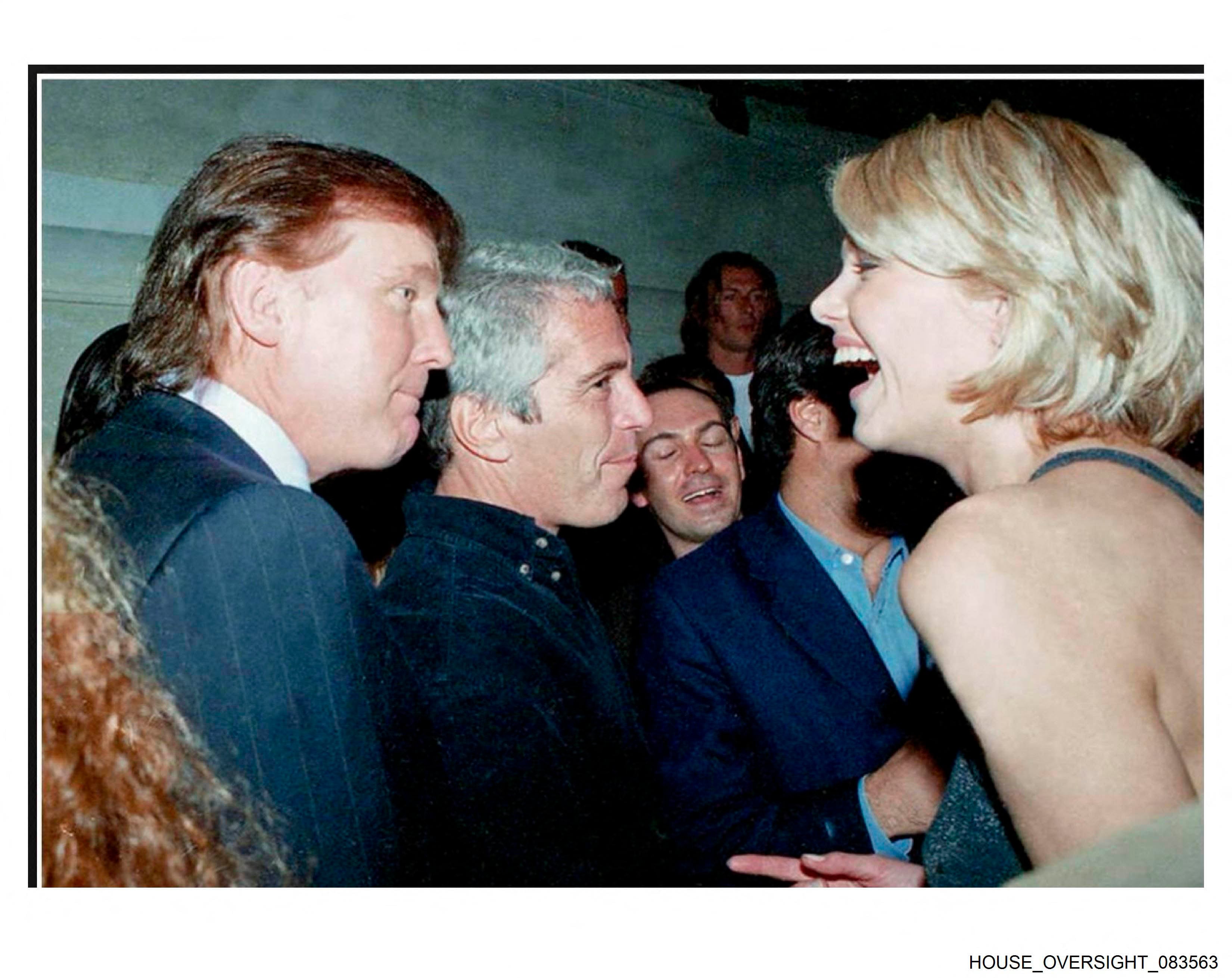 This undated photo from the personal collection of Jeffrey Epstein provided by the Democrats on the House Oversight Committee on December 12, 2025, shows US President Donald Trump (L), flanked by Epstein (C), talking to an unknown woman. Democratic lawmakers released a new cache of photos on Friday from the estate of convicted sex offender Jeffrey Epstein that includes images of US President Donald Trump and former president Bill Clinton, as well as former Trump advisor Steve Bannon, former Clinton treasury secretary Larry Summers, director Woody Allen and the ex-prince now known as Andrew Mountbatten-Windsor. (Photo by HANDOUT / House Oversight Democrats / AFP) / RESTRICTED TO EDITORIAL USE - MANDATORY CREDIT "AFP PHOTO / HOUSE OVERSIGHT COMMITTEE DEMOCRATS / HANDOUT / " - NO MARKETING NO ADVERTISING CAMPAIGNS - DISTRIBUTED AS A SERVICE TO CLIENTS