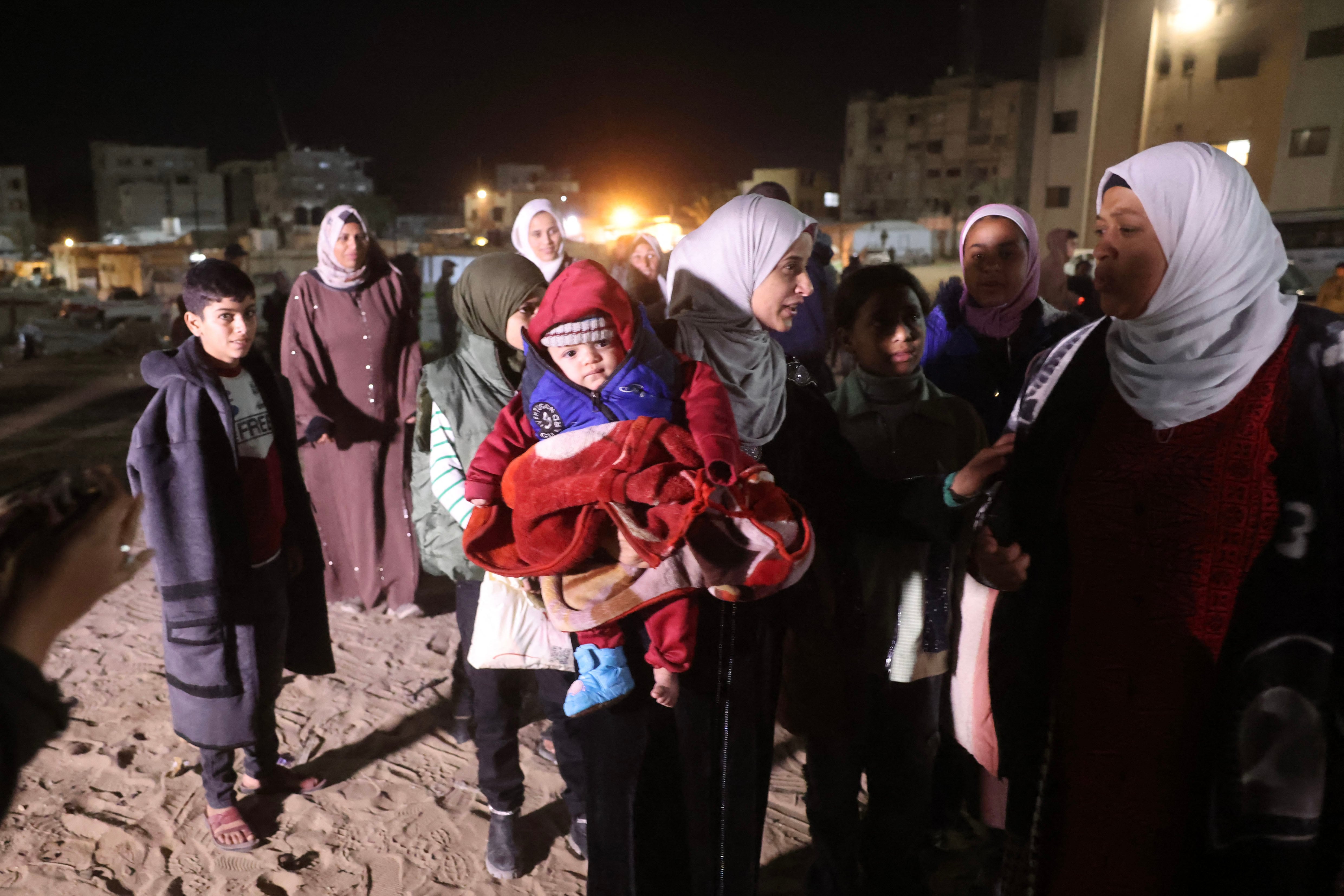 Palestinians, coming from the Rafah crossing with Egypt, arrive at Nasser Hospital in Khan Yunis in the southern Gaza Strip on February 4, 2026. Gazans long-separated from their loved ones shed tears of joy after the limited reopening of the Rafah crossing with Egypt allowed a handful to finally return to the war-shattered territory. Jubilant crowds filmed on their phones as they flocked around a bus carrying returnees to Nasser Hospital in the southern city of Khan Yunis late in the night. (Photo by Bashar Taleb / AFP)