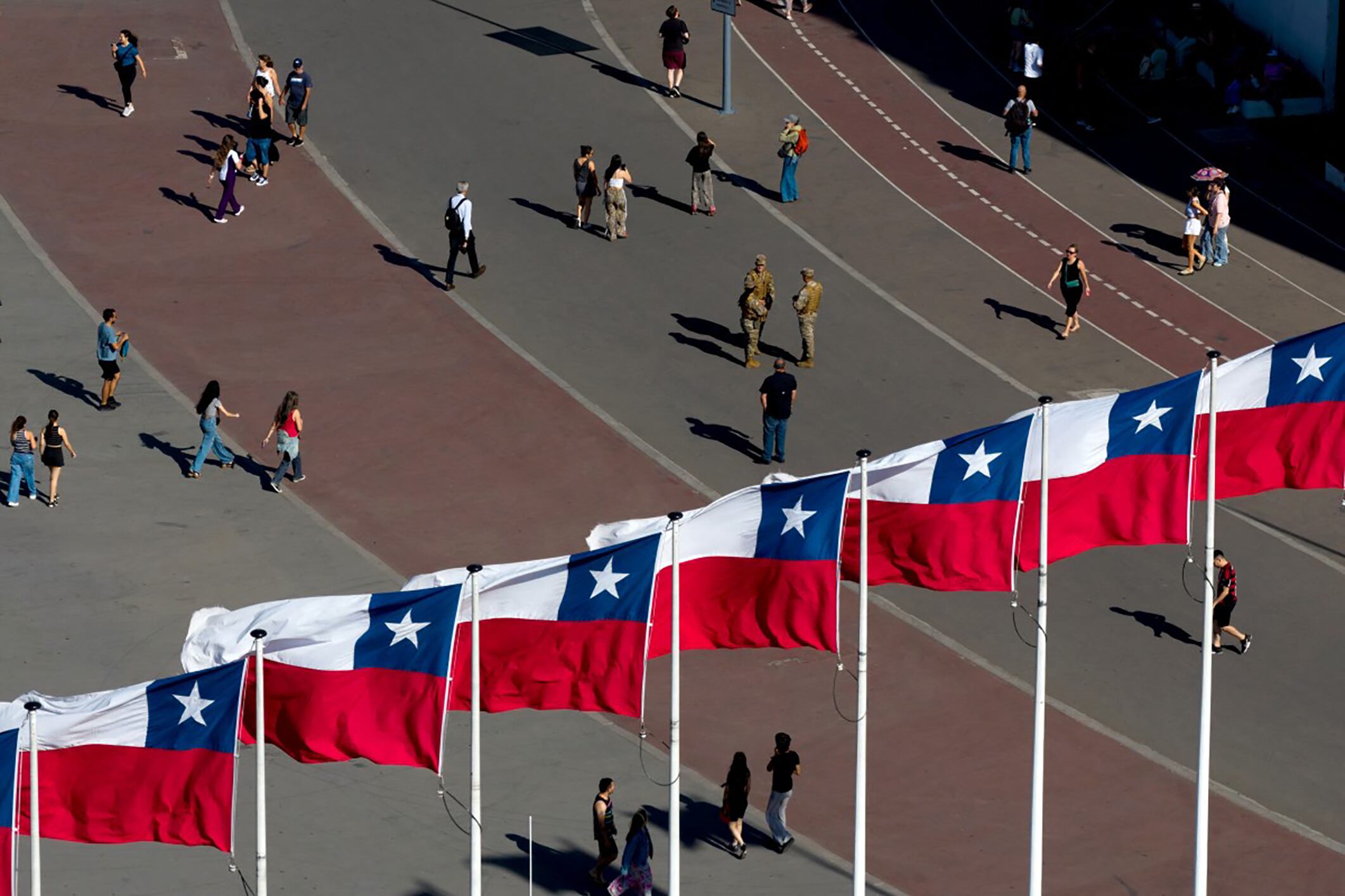Aerial view of Chilean flags waving next to the National Stadium serving as a polling station during the general election in Santiago taken on November 16, 2025. Chileans are voting in a presidential election shaped by rising concerns over violent crime, with candidates pledging tougher measures against transnational gangs and the far-right promising to carry out mass migrant deportations. (Photo by Javier TORRES / AFP)