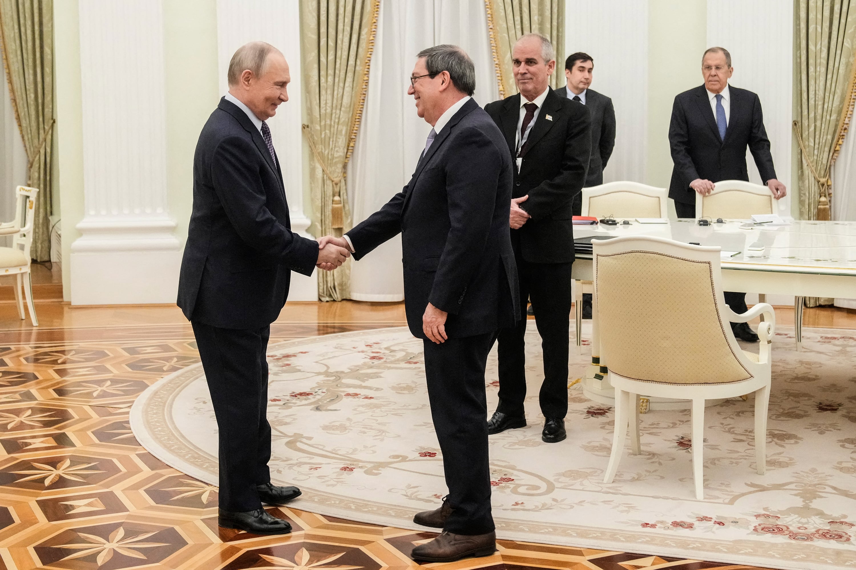 Russian President Vladimir Putin greets Cuban Foreign Minister Bruno Rodriguez Parrilla