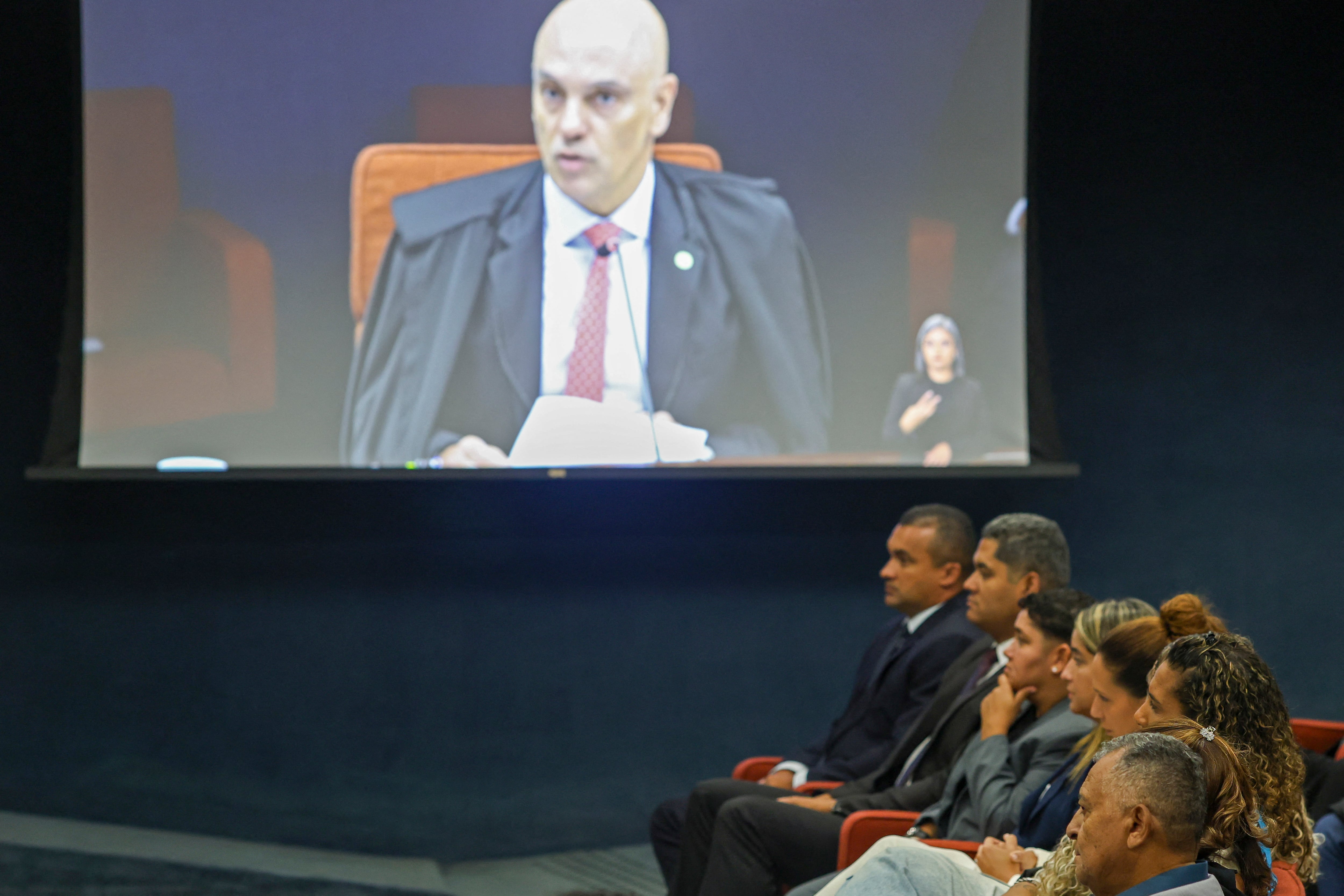 Brazil's Supreme Federal Court Vice-President Alexandre de Moraes, rapporteur of the plenary session of the first chamber, is seen on a screen during the first session of the trial of those suspected of ordering the assassination of Brazilian councilwoman Marielle Franco in 2018,