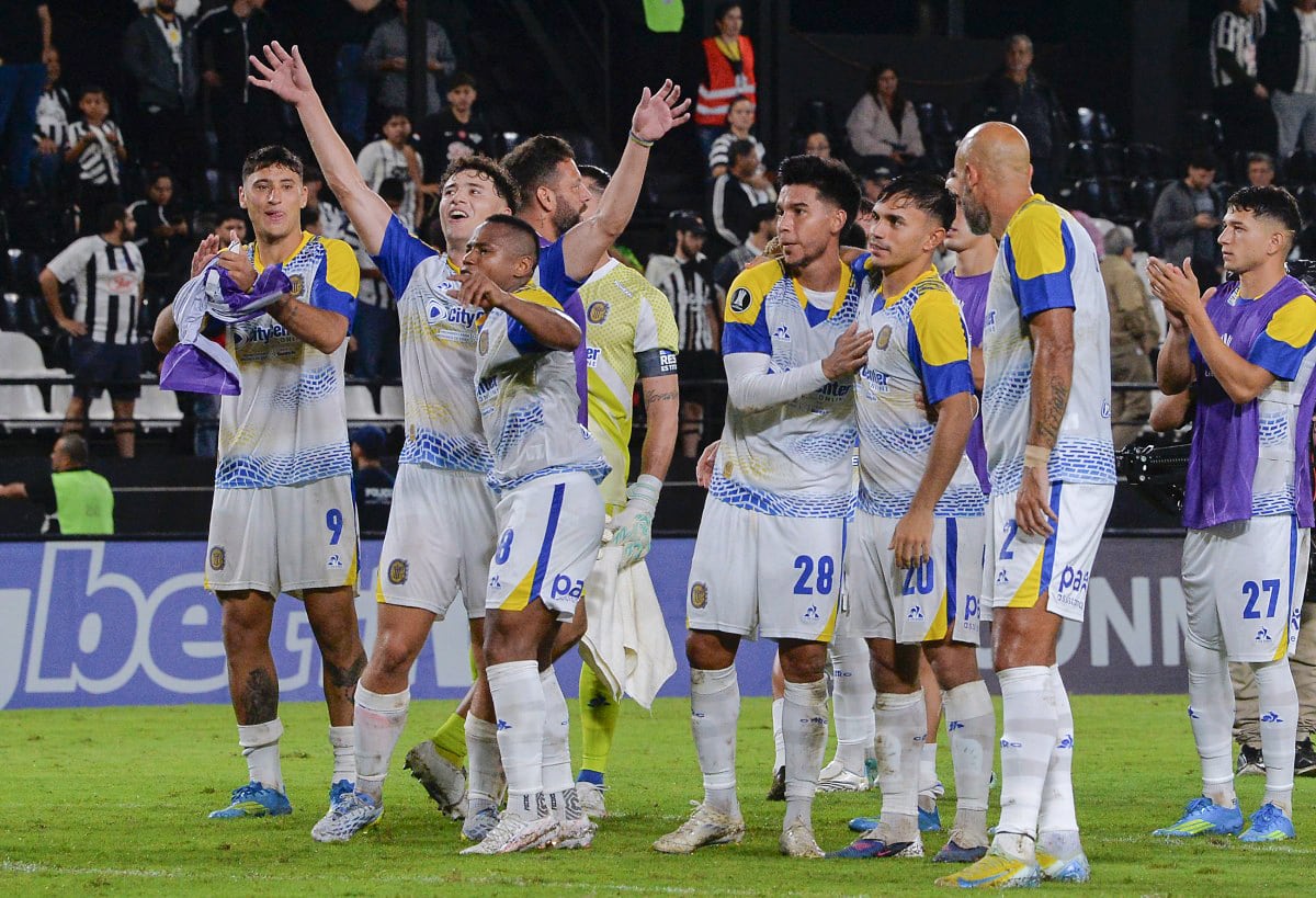 Rosario Central players celebrate after winning the Copa Libertadores group