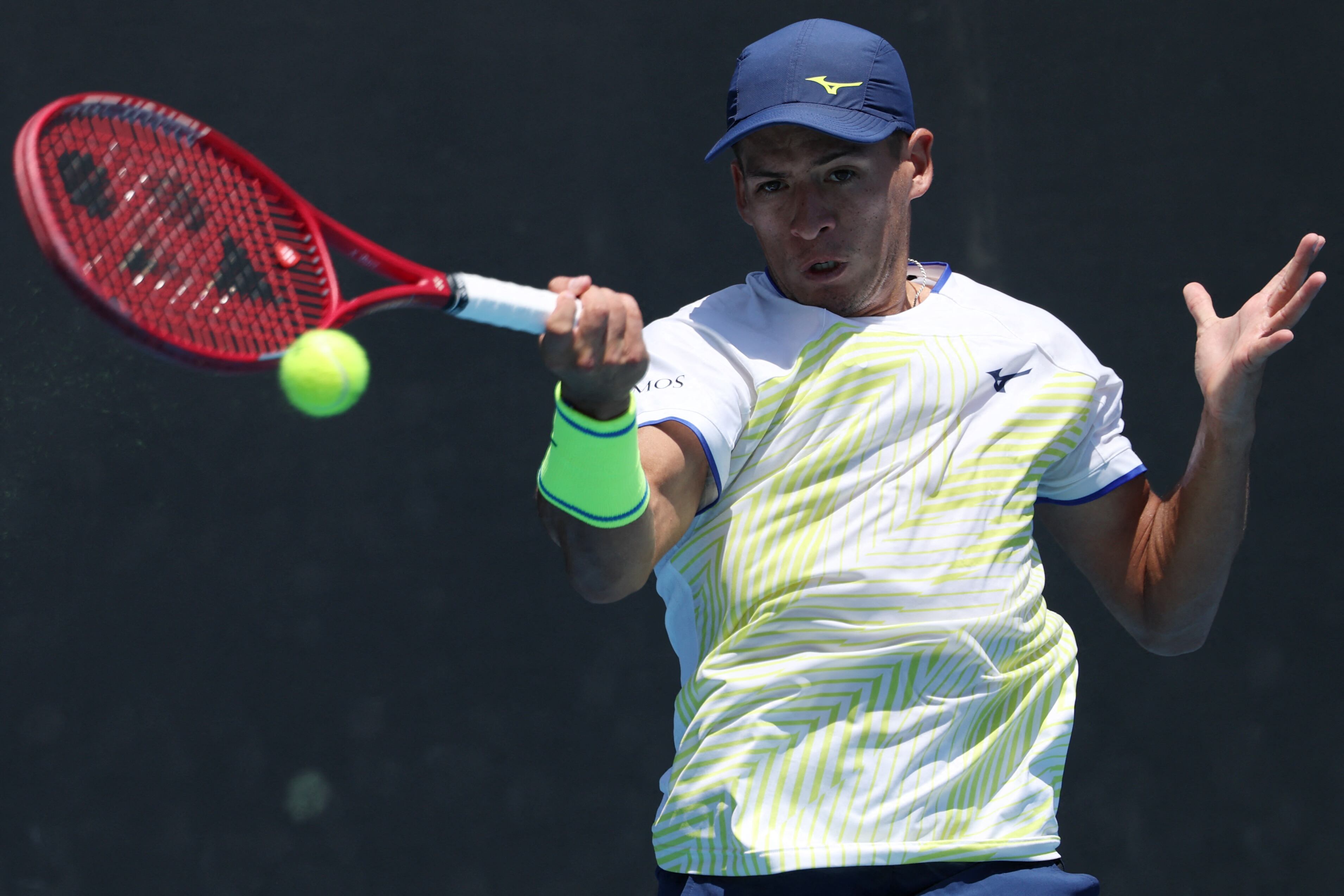 Argentina�s Sebastian Baez hits a return against France�s Giovanni Mpetshi Perricard during their men's singles match on day three of the Australian Open tennis tournament in Melbourne on January 20, 2026. (Photo by IZHAR KHAN / AFP) / -- IMAGE RESTRICTED TO EDITORIAL USE - STRICTLY NO COMMERCIAL USE --