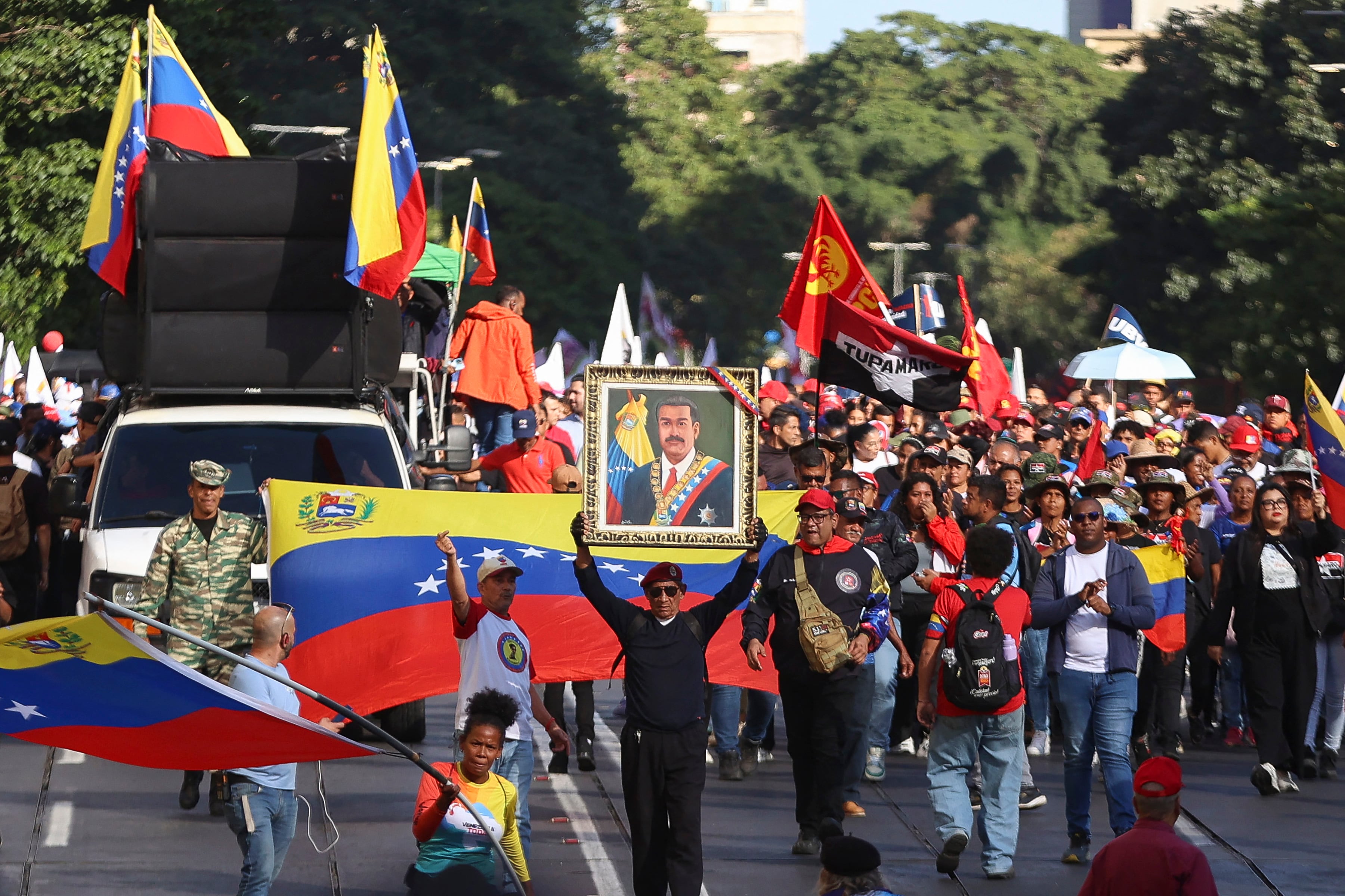 Government supporters march one month after the ouster of Venezuelan President Nicolas Maduro and First Lady Cilia Flores in Caracas on February 3, 2026. (Photo by Pedro MATTEY / AFP)