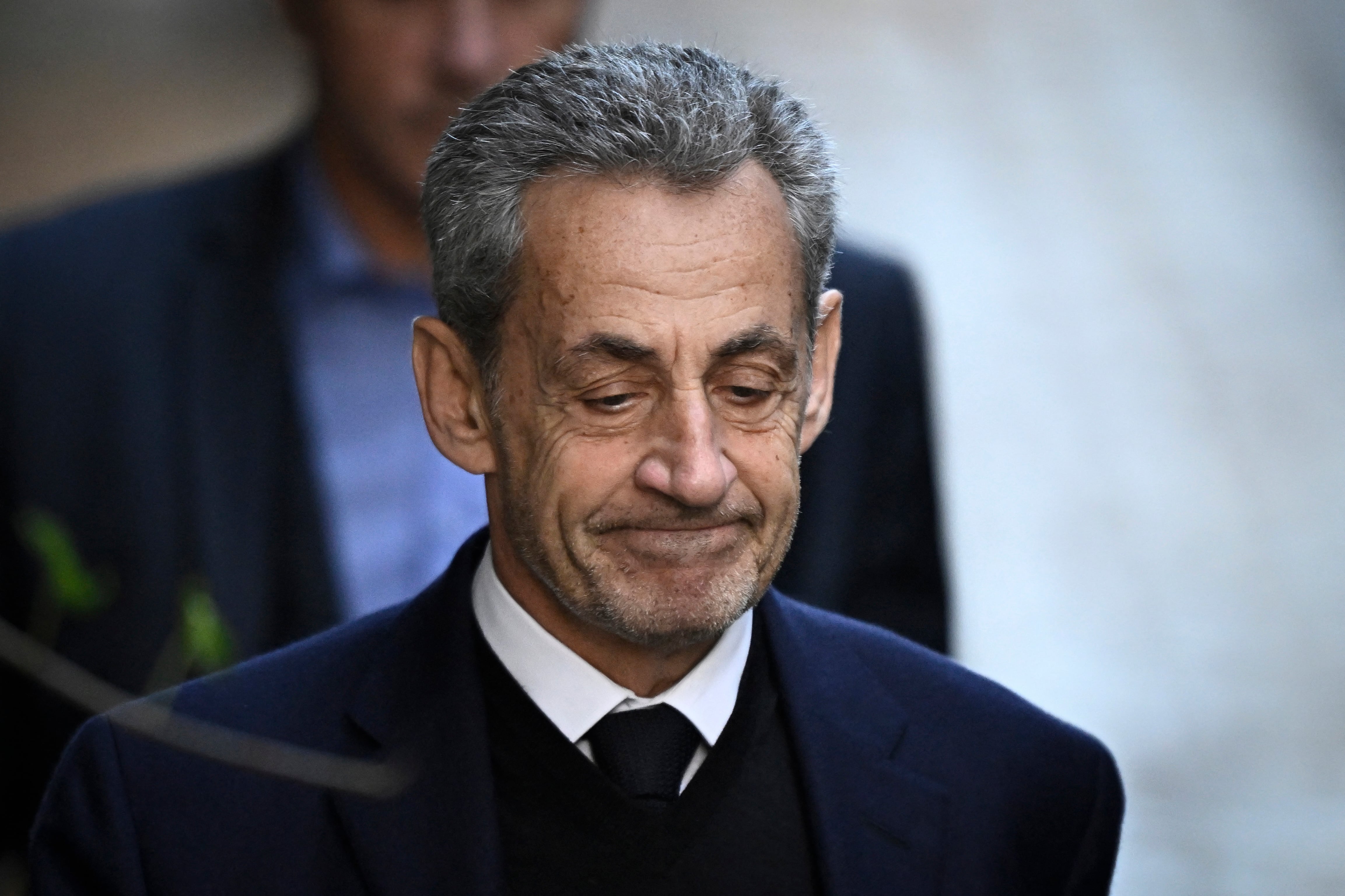 France's former president Nicolas Sarkozy leaves his residence to present himself to La Sante Prison for incarceration on a five-year prison sentence after being convicted of criminal conspiracy over a plan for late Libyan dictator Moamer Kadhafi to fund his 2007 electoral campaign, in Paris, on October 21, 2025. Nicolas Sarkozy, who has faced a flurry of legal woes since losing re-election in 2012, is to be jailed on October 21, 2025, over a scheme to acquire Libyan funding for his successful 2007 presidential run, becoming the first former head of a European Union country to serve time behind bars. The former French right-wing leader has appealed the verdict and denounced an "injustice". (Photo by JULIEN DE ROSA / AFP)
