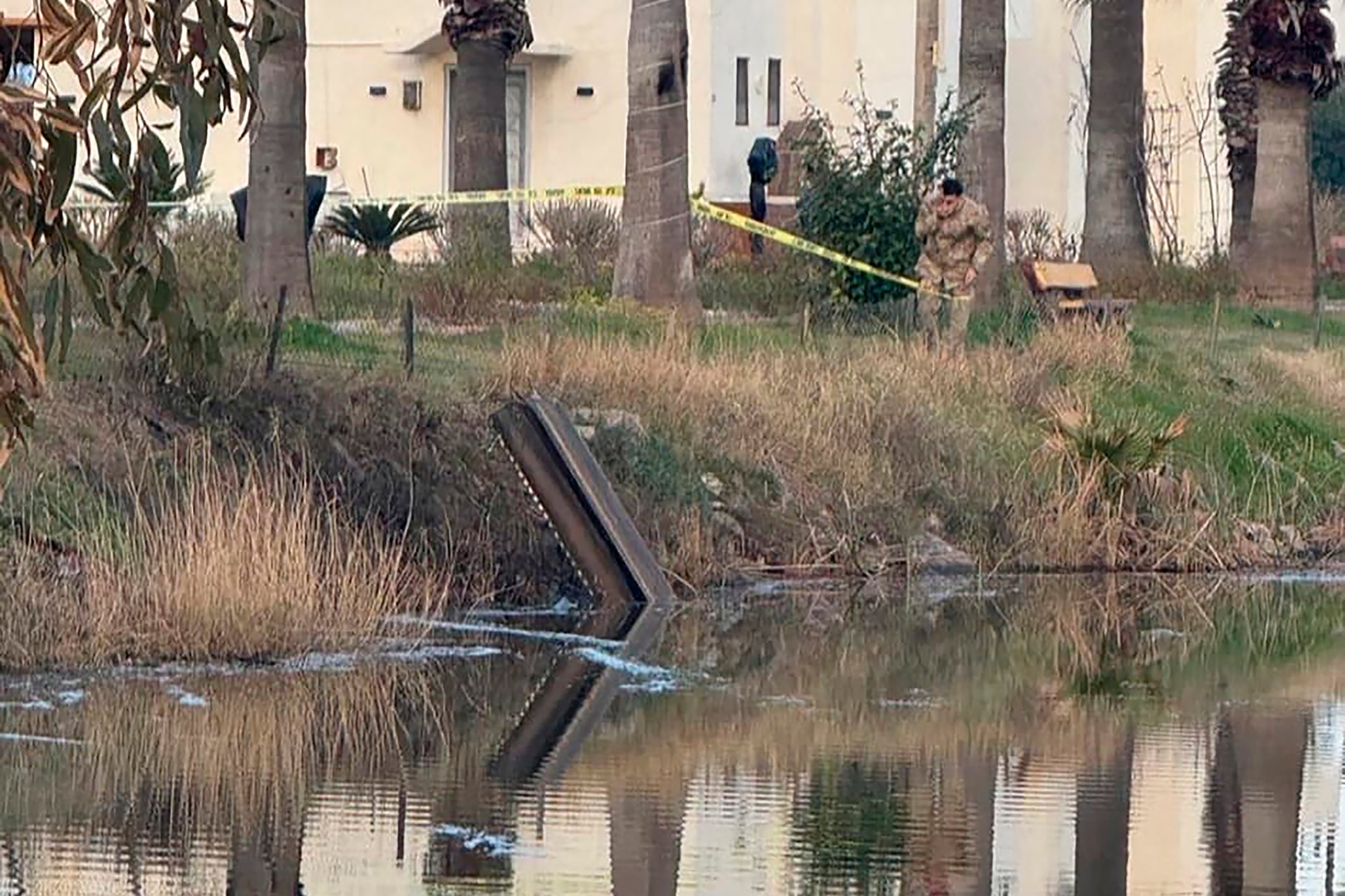 This handout photograph taken and released on March 4, 2026 by Turkish news agency DHA (Demiroren News Agency) shows Turkish soldiers surround a munitions fragment identified as belonging to the air defence munitions that intercepted the threat after it was destroyed in the air, at dortyol district in Hatay. Turkey warned Tehran against any steps that could spread the war after a missile launched from Iran heading toward Turkish airspace was destroyed by NATO air-defence systems, a foreign ministry source said. (Photo by HANDOUT / DHA (Demiroren News Agency) / AFP) / Turkey OUT / TURKEY OUT / RESTRICTED TO EDITORIAL USE - MANDATORY CREDIT "AFP PHOTO / DHA (DEMIROREN NEWS AGENCY) " - NO MARKETING NO ADVERTISING CAMPAIGNS - DISTRIBUTED AS A SERVICE TO CLIENTS