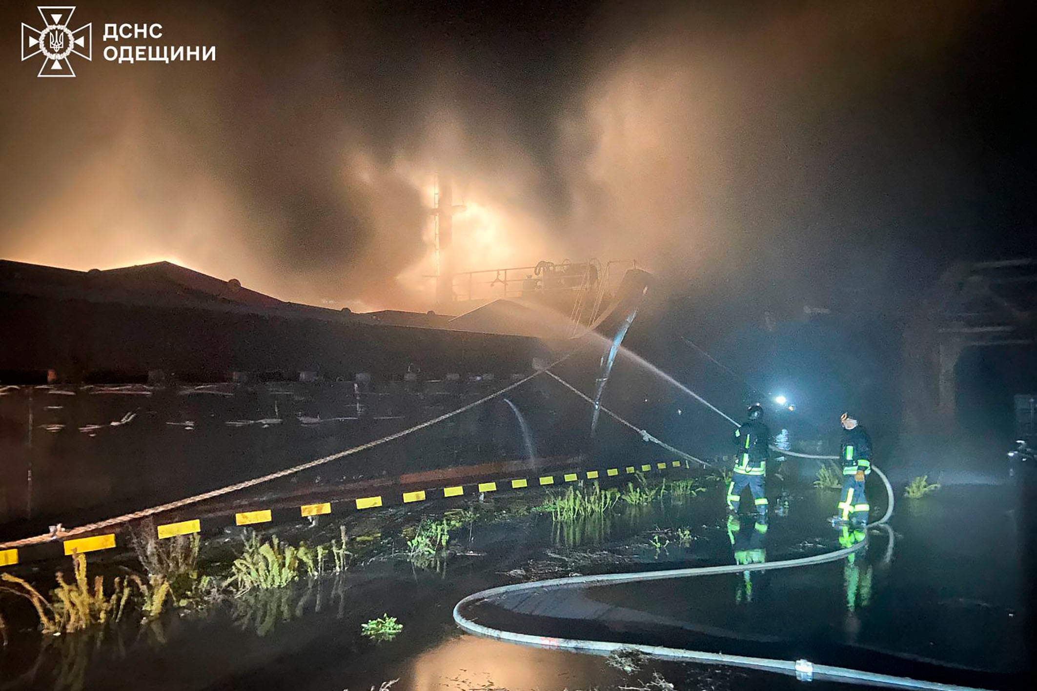 This handout photograph taken and released by the Ukrainian Emergency Service on December 23, 2025, shows Ukrainian rescuers reportedly working to extinguish a fire on a civilian cargo vessel following an alleged air attack at a port in Odesa region, amid the Russian invasion of Ukraine. (Photo by Handout / UKRAINIAN EMERGENCY SERVICE / AFP) / RESTRICTED TO EDITORIAL USE - MANDATORY CREDIT "AFP PHOTO / UKRAINIAN EMERGENCY SERVICE" -  HANDOUT - NO MARKETING NO ADVERTISING CAMPAIGNS - DISTRIBUTED AS A SERVICE TO CLIENTS - AFP CANNOT INDEPENDENTLY VERIFY THE AUTHENTICITY OR LOCATION, DATE, AND CONTENT OF THESE IMAGES. /
