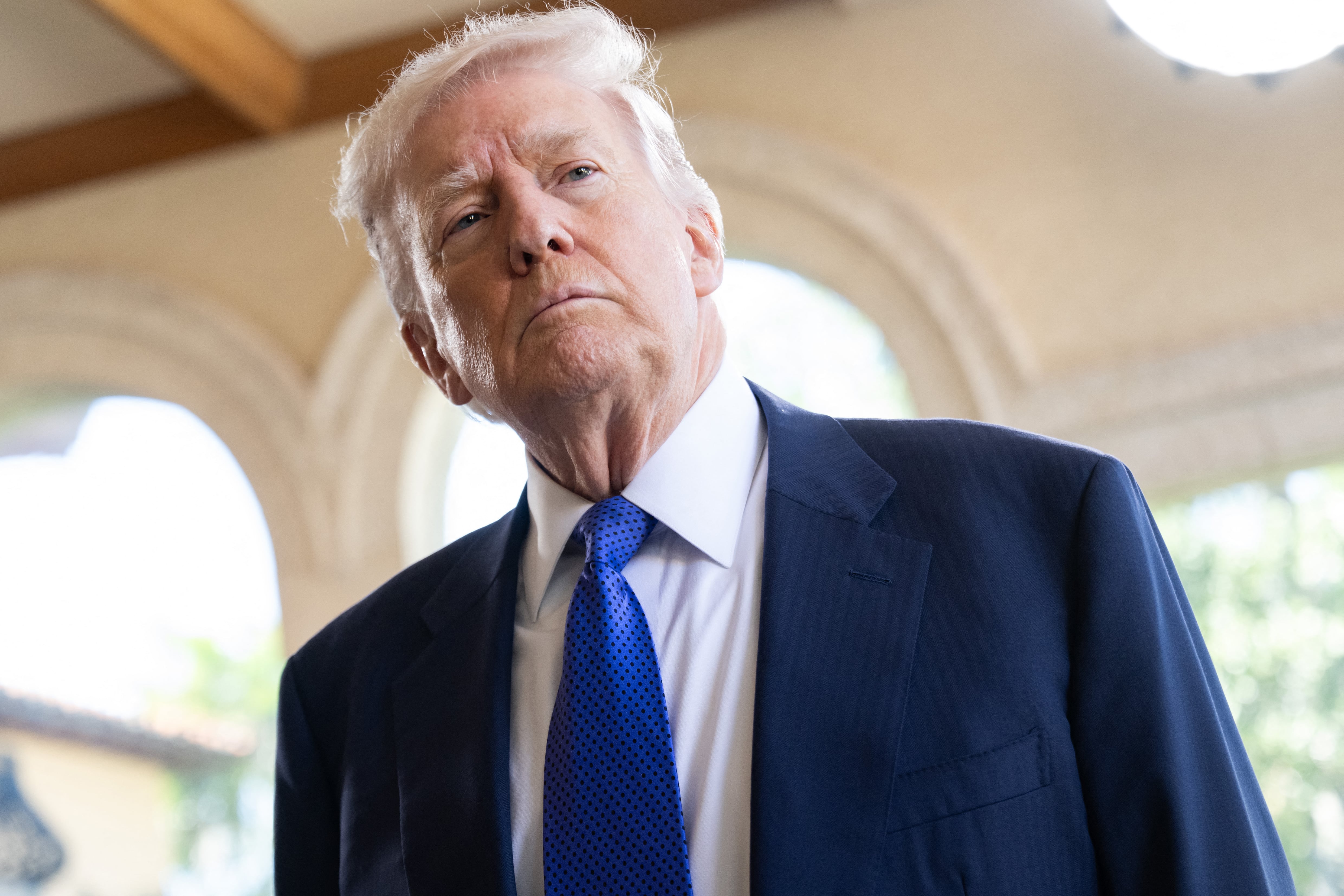 US President Donald Trump speaks to the press as he arrives to attend the wedding of Dan Scavino, White House Deputy Chief of Staff, and Erin Elmore, the Department of State Director of Art in Embassies, at Mar-a-Lago in Palm Beach, Florida, February 1, 2026. (Photo by SAUL LOEB / AFP)