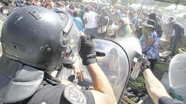 La policía cargó contra los feriantes, vecinos y los periodistas allí apostados.