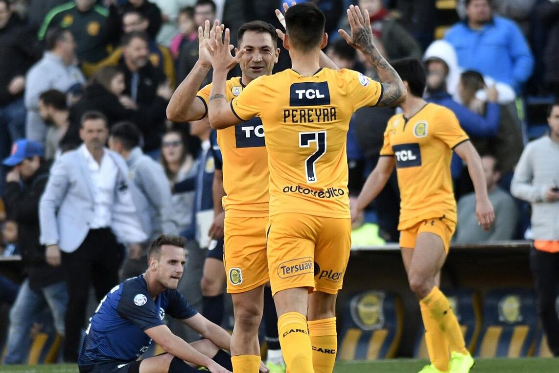 Pereyra, uno de los pocos juveniles utilizados por Cocca, se saluda con Rinaudo, mediocampista de mil batallas.