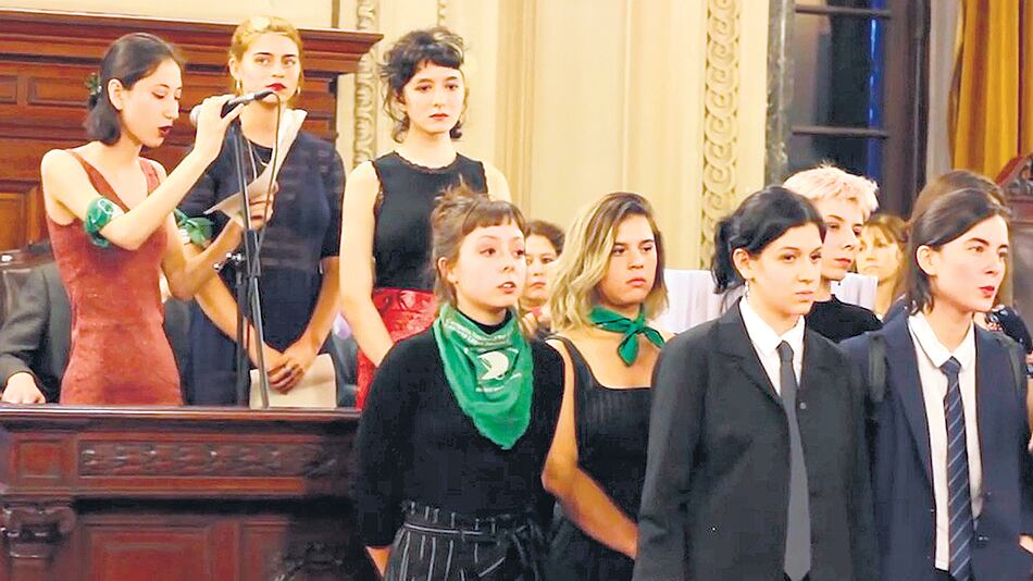 El acto: Ema Graña (arriba, en el centro), Zoe Taricco (adelante, con pañuelo verde al cuello) y Cata Gobelli, de corbata a su derecha.