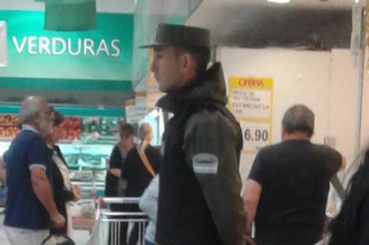 Un gendarme vigila a los clientes de La Anónima.