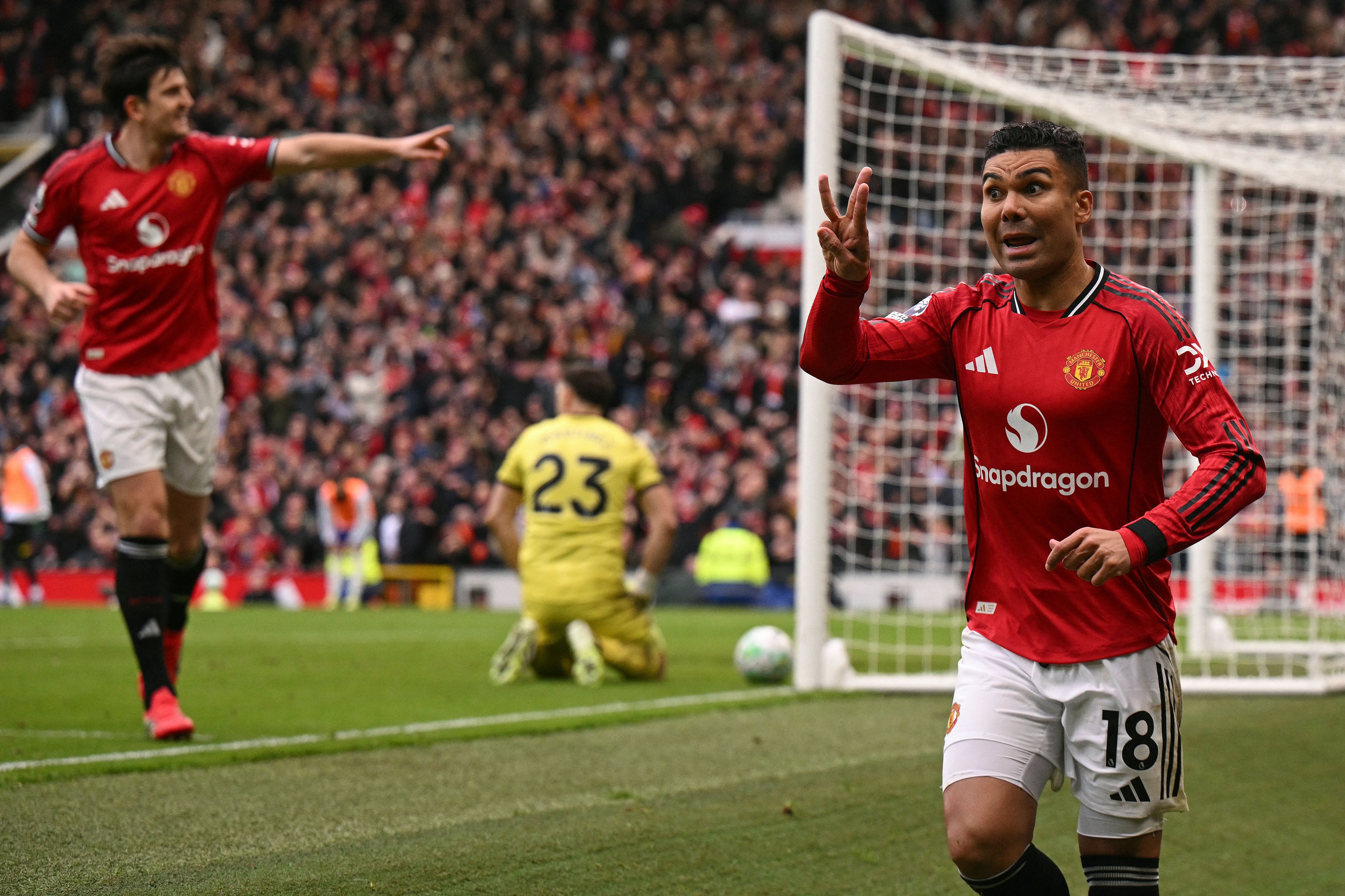 Manchester United's Brazilian midfielder #18 Casemiro (R) celebrates after scoring the team's first goal during the English Premier League football match between Manchester United and Aston Villa at Old Trafford in Manchester, north west England, on March 15, 2026. (Photo by Oli SCARFF / AFP) / RESTRICTED TO EDITORIAL USE. No use with unauthorized audio, video, data, fixture lists, club/league logos or 'live' services. Online in-match use limited to 120 images. An additional 40 images may be used in extra time. No video emulation. Social media in-match use limited to 120 images. An additional 40 images may be used in extra time. No use in betting publications, games or single club/league/player publications. /