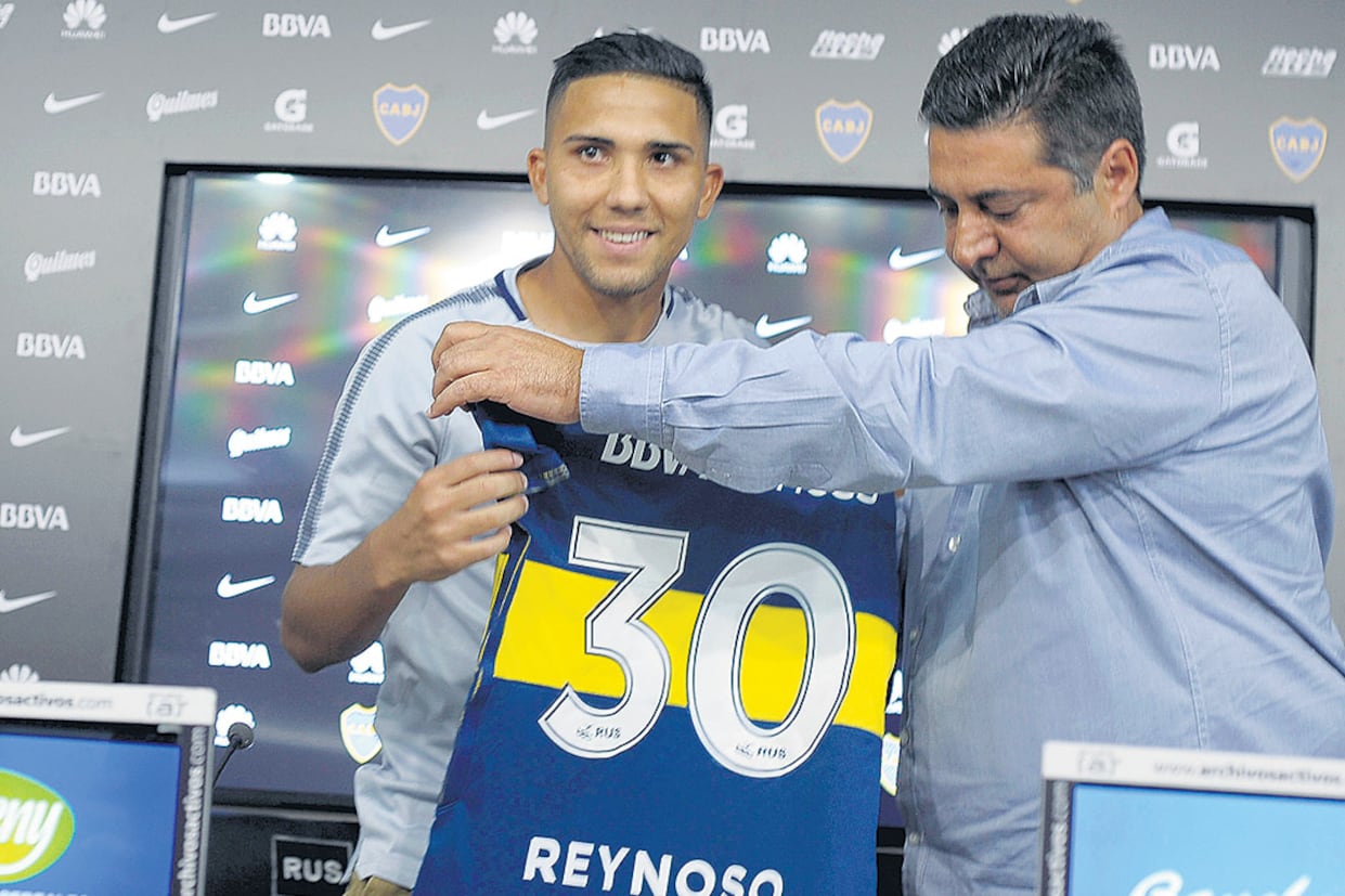 Daniel Angelici y Emanuel Reynoso, ayer durante la presentación oficial.