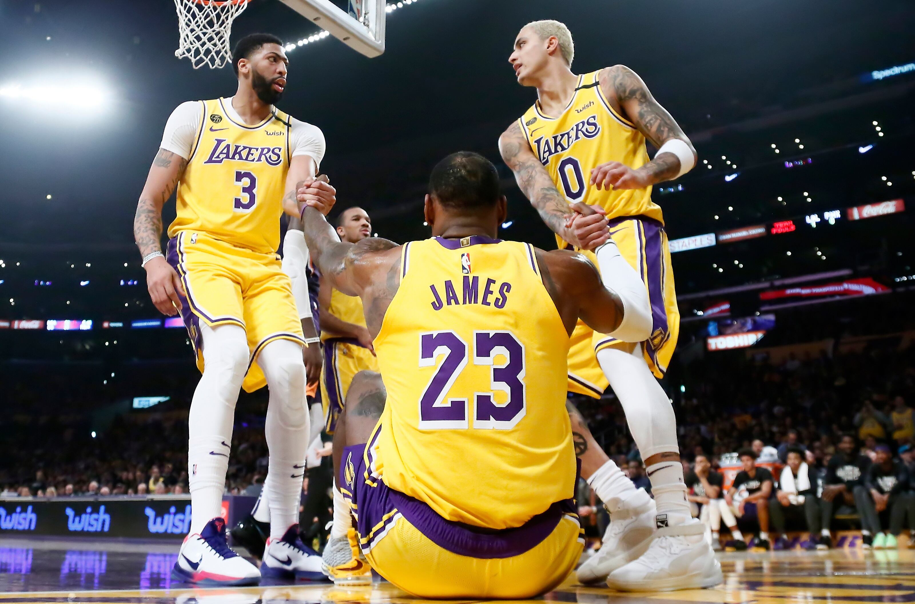 Anthony Davis y Kyle Kuzma ayudan a levantarse a LeBron James, la gran figura del equipo.