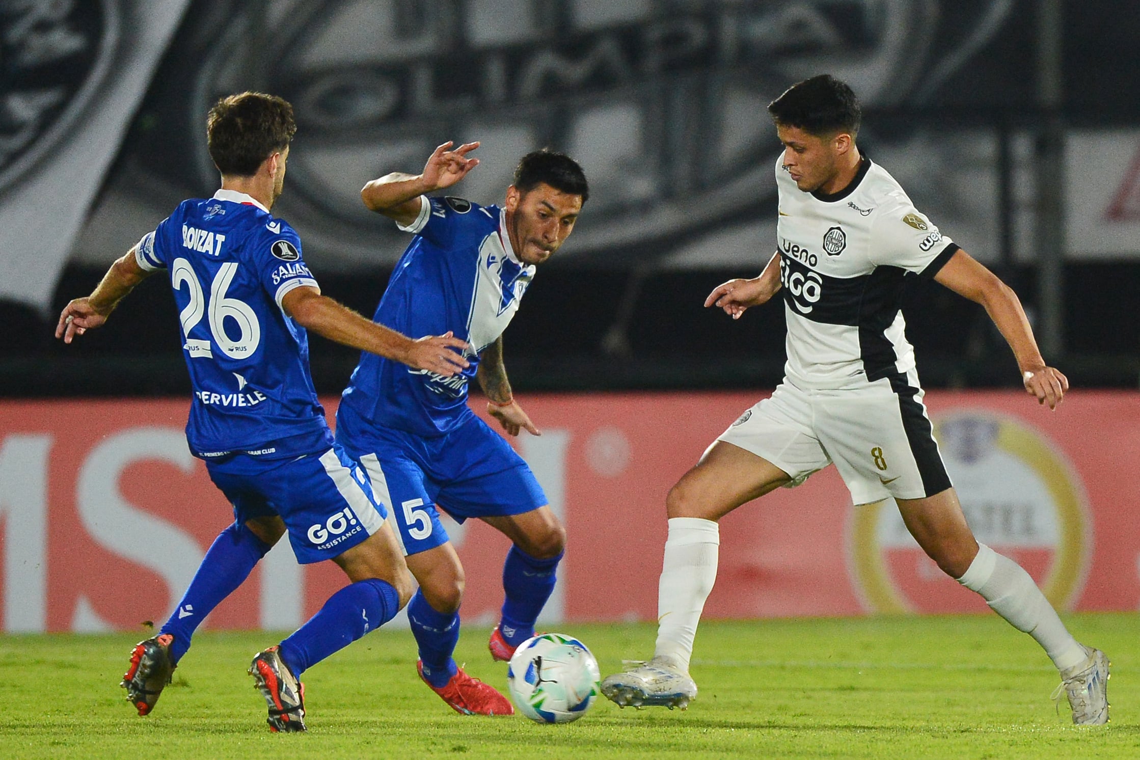 Baeza y Franco se disputan la pelota con la presencia de Bouzat