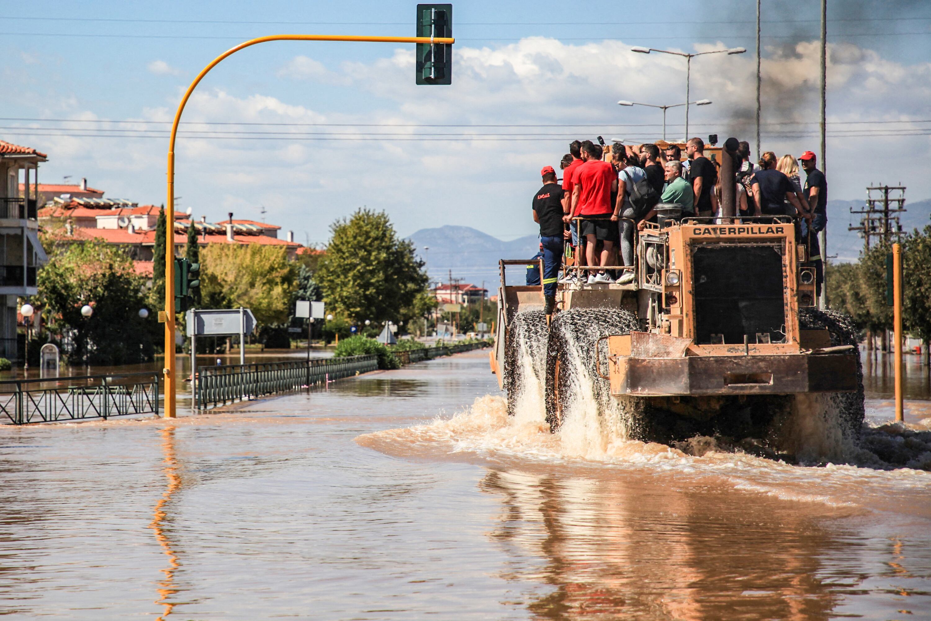 Un grupo de personas son evacuadas en una excavadora Caterpillar en una zona inundada en Larisa, en el centro de Grecia