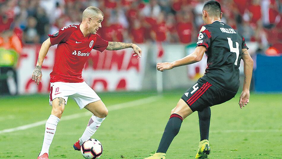 D’Alessandro intenta escapar de la marca de Angileri, cerca del área de River.