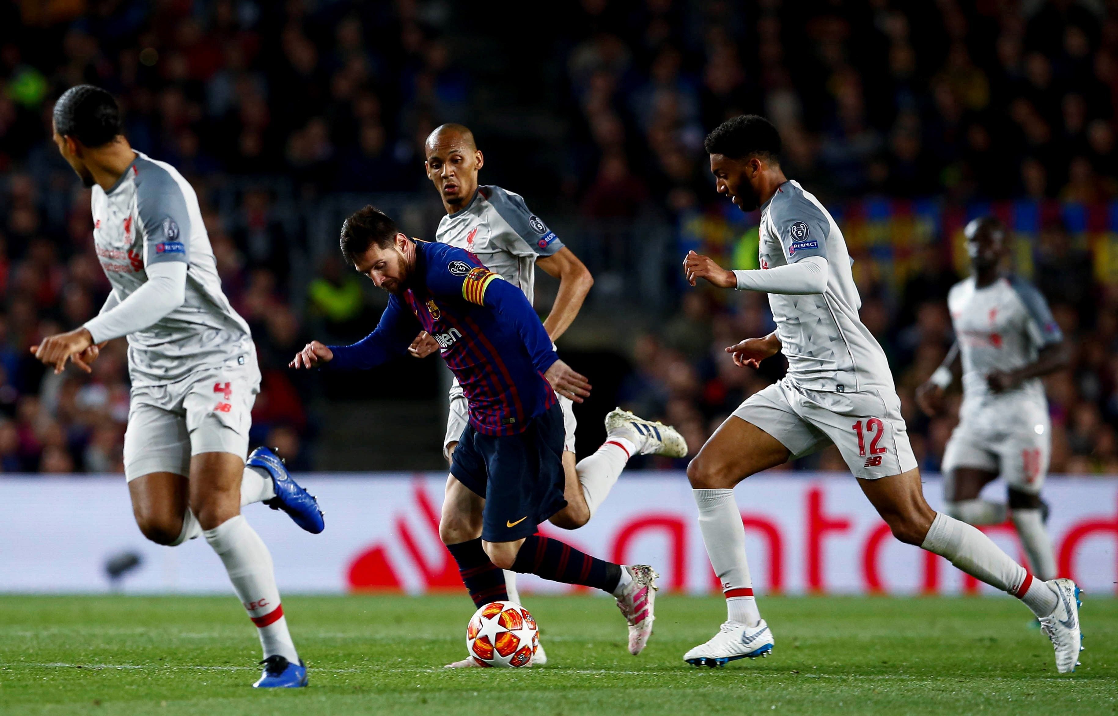 Messi avanza rodeado por jugadores del Liverpool: hizo dos goles y acercó al Barça a la final de Madrid.