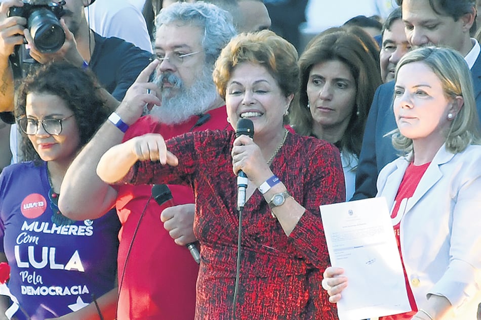 Discurso de Dilma mientras Gleisi sostiene la inscripción de Lula, ayer en Brasilia.