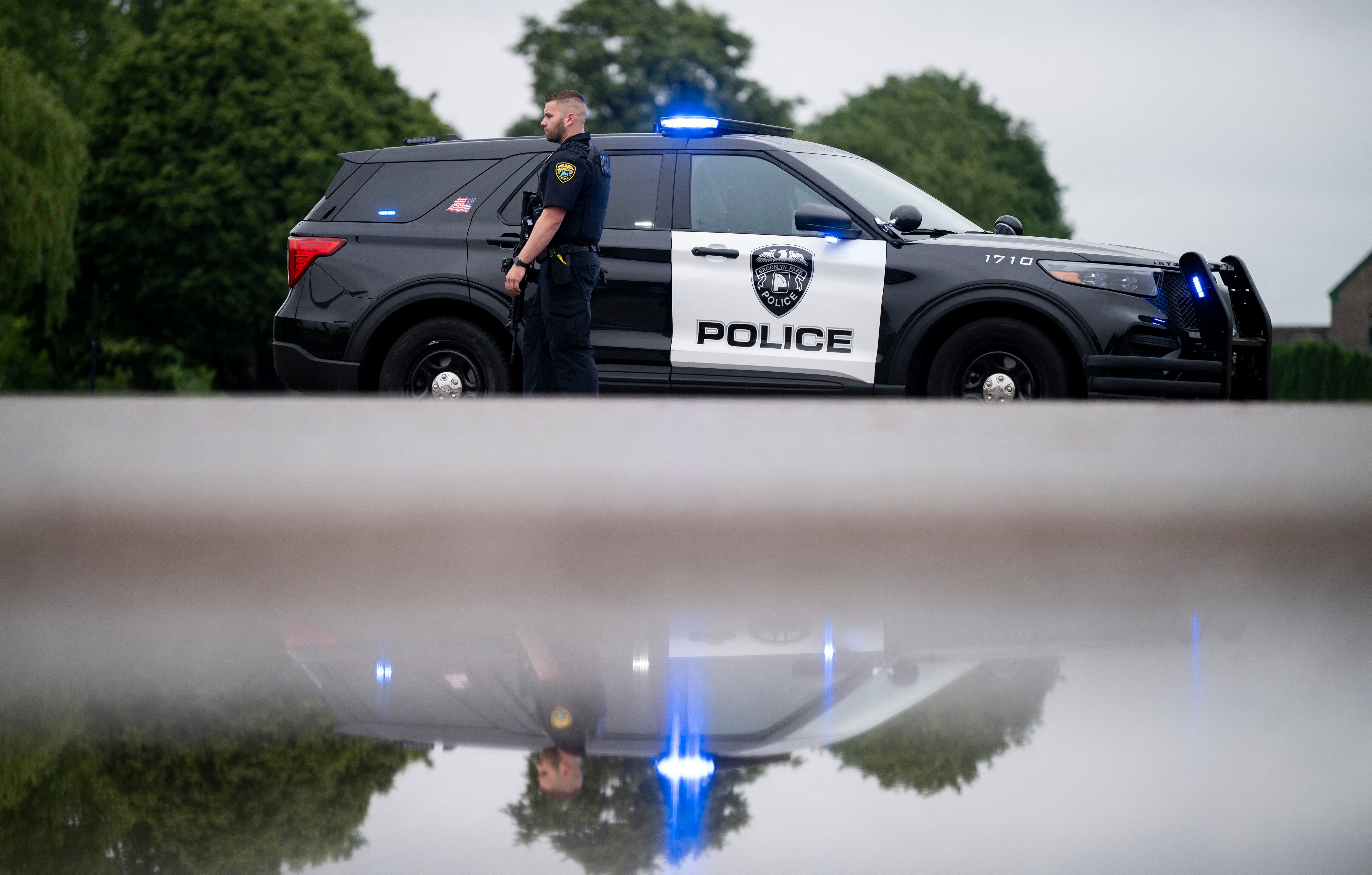 Un oficial de policía de Brooklyn Park observa mientras custodia la entrada a un vecindario el 14 de junio de 2025 en Brooklyn Park, Minnesota.