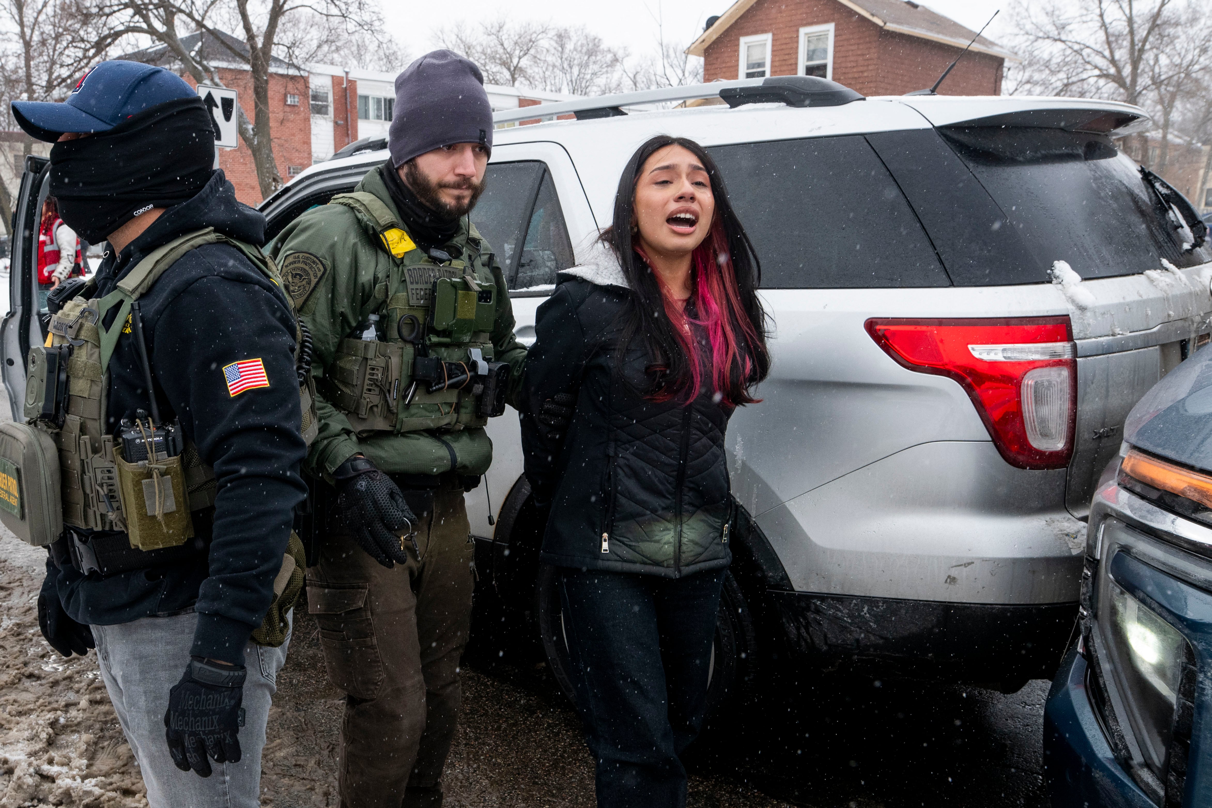 MINNEAPOLIS, MINNESOTA - JANUARY 21: A teenage girl is arrested on Blaisdell Avenue after colliding with a Border Patrol vehicle on January 21, 2026 in Minneapolis, Minnesota. A teenage boy and girl, and multiple observers, were arrested by Border Patrol after the incident. The Trump administration has sent a reported 3,000 federal plus federal agents into the area, with more on the way, as they make a push to arrest undocumented immigrants in the region.   Stephen Maturen/Getty Images/AFP (Photo by Stephen Maturen / GETTY IMAGES NORTH AMERICA / Getty Images via AFP)