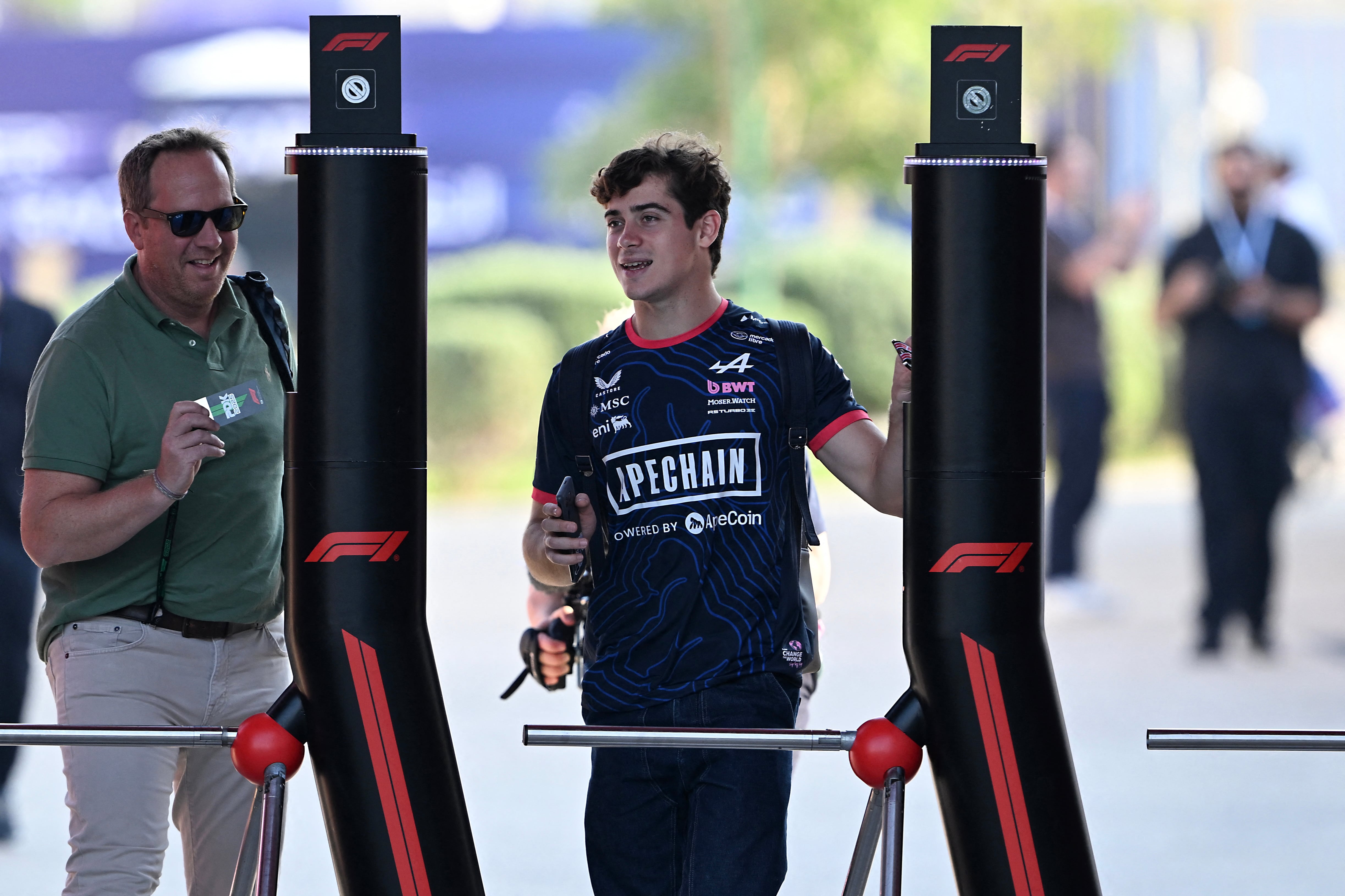 Alpine's Argentinian driver Franco Colapinto (C) arrives at the Lusail International Circuit ahead of the Formula One Qatar Grand Prix in Lusail on November 27, 2025. (Photo by MAHMUD HAMS / AFP)