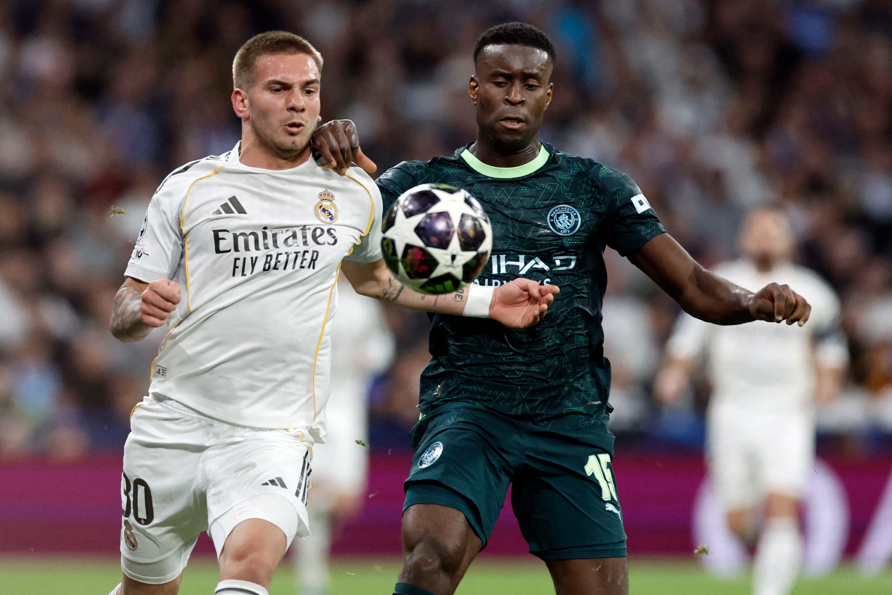 Real Madrid's Argentinian midfielder #30 Franco Mastuantono and Manchester City's English defender #15 Marc Guehi fight for the ball during the UEFA Champions League last 16 first leg football match between Real Madrid CF and Manchester City at Santiago Bernabeu Stadium in Madrid on March 11, 2026. (Photo by Oscar DEL POZO / AFP)