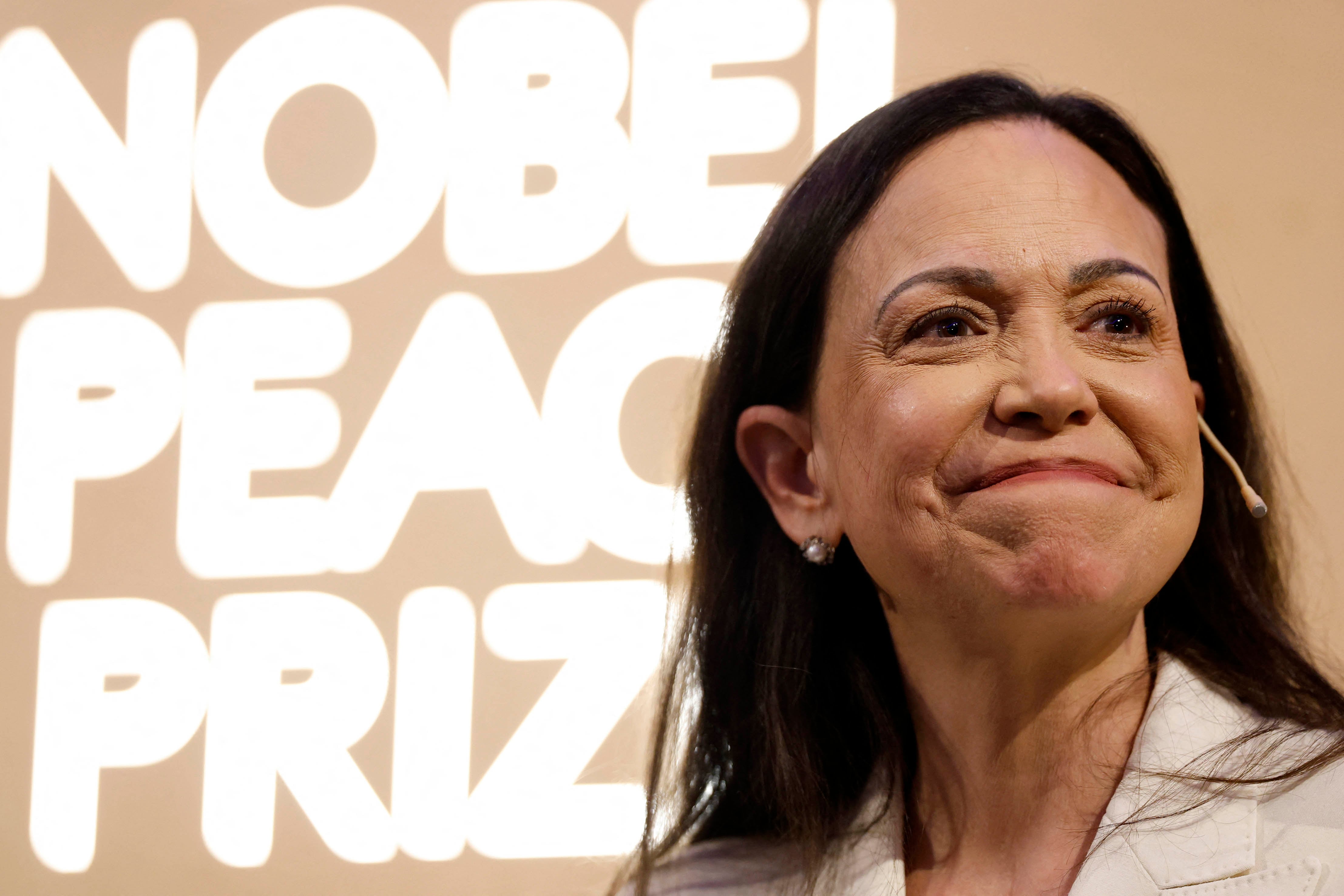 Nobel peace prize laureate Maria Corina Machado smiles as she addresses a press conference at the Grand Hotel in Oslo, Norway, on December 11, 2025. The 58-year-old, who has been in hiding in her home country since June 2024, missed the award of the Nobel Prize in Oslo on December 10. But she waved to supporters from her hotel shortly after arriving during the night. Maria Corina Machado is the lynchpin of opposition to Venezuelan President Nicolas Maduro's regime, a fearless activist with rock star appeal whose inability to attend her own Nobel prize ceremony underlined the dangers she faces. (Photo by Odd ANDERSEN / AFP)