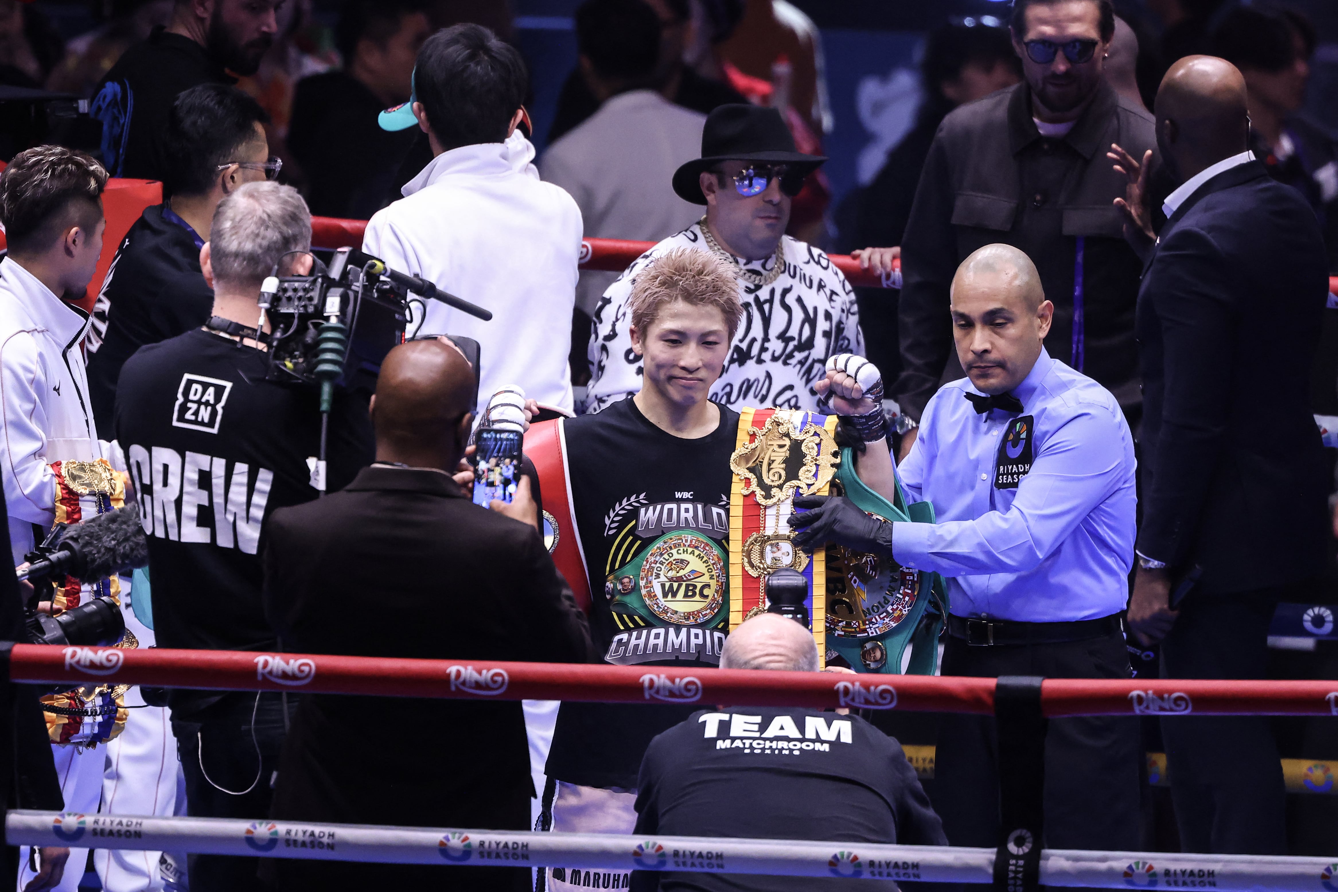 Japan's boxer Naoya Inoue celebrates with the winner's belt after beating Mexico's boxer David Picasso in the "The Ring V night of Samurai" final major fight card of the year at the Mohammed Abdo Arena in Riyadh on December 27, 2025. (Photo by Fayez NURELDINE / AFP)
