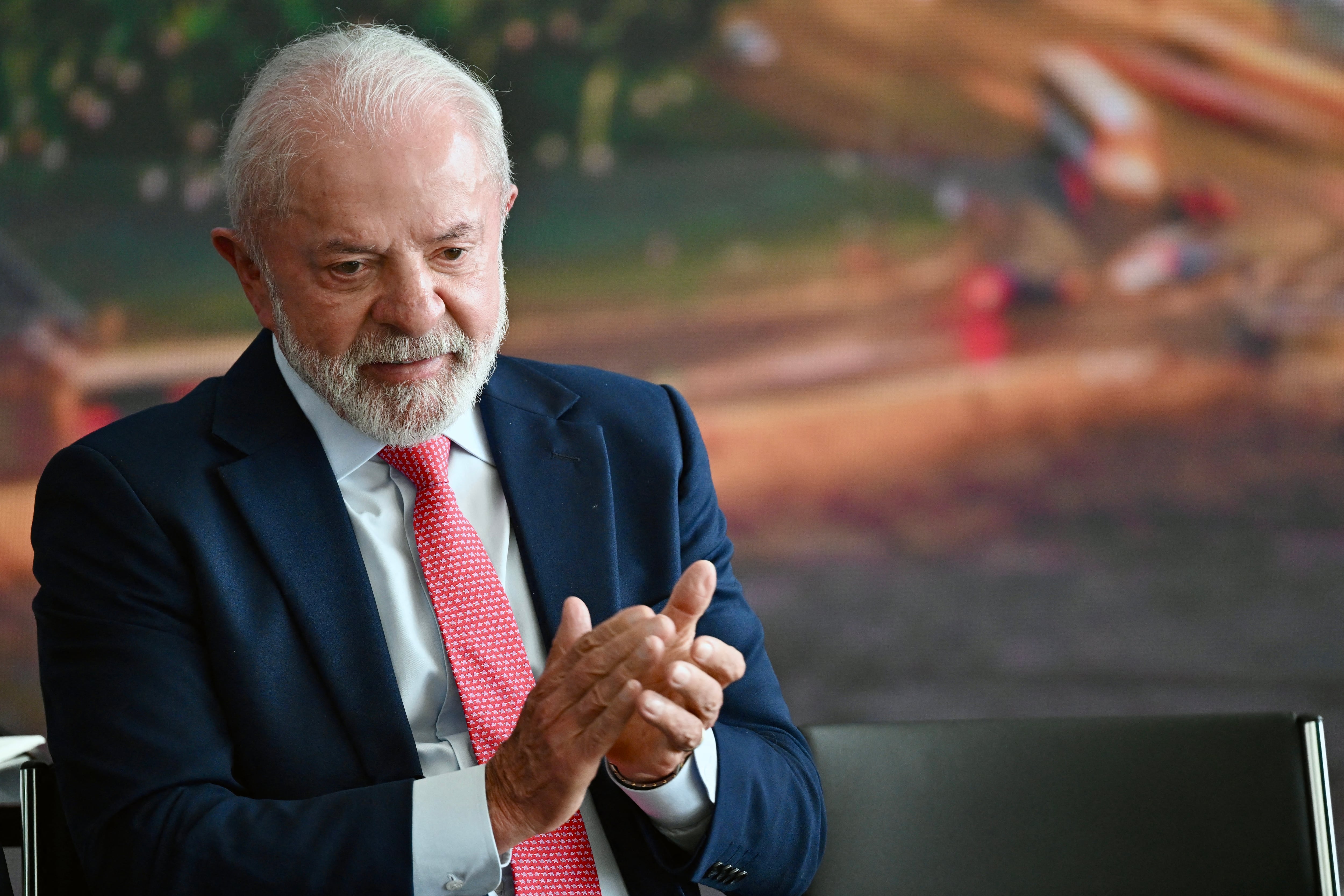 Brazil�s President Luiz Inacio Lula da Silva applauds during the Ceremony in Defense of Democracy marking the third anniversary of the attempted coup d'�tat involving the invasion and destruction of buildings of the three branches of government, at the Planalto Palace in Bras�lia, on January 8, 2026. (Photo by Evaristo Sa / AFP)