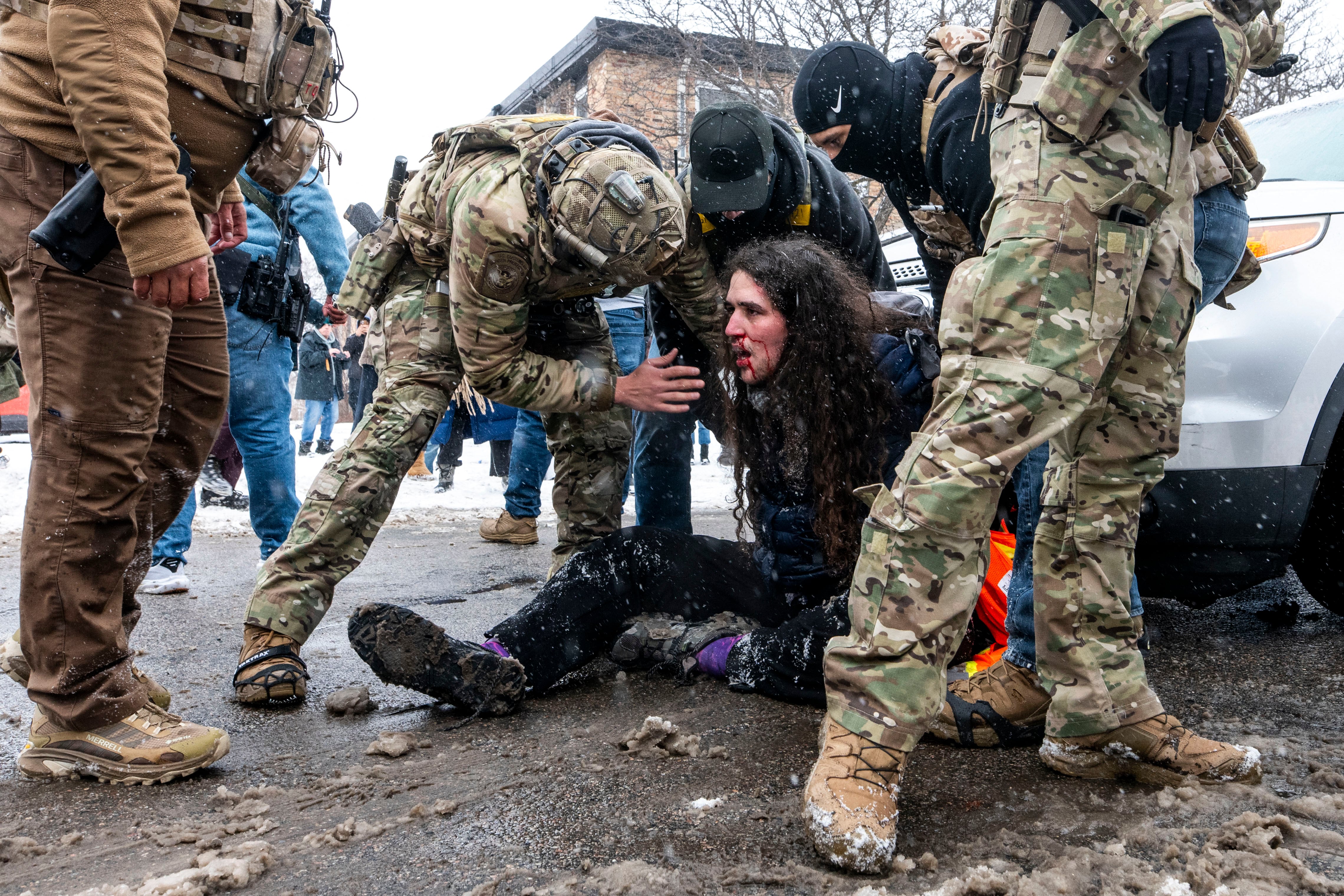 MINNEAPOLIS, MINNESOTA - JANUARY 21: A person is detained after confronting Border Patrol as they were arresting two teenagers after a car accident on January 21, 2026 in Minneapolis, Minnesota. The driver and passenger of a vehicle and several observers were arrested by Border Patrol after the incident. The Trump administration has sent a reported 3,000 federal plus federal agents into the area, with more on the way, as they make a push to arrest undocumented immigrants in the region.   Stephen Maturen/Getty Images/AFP (Photo by Stephen Maturen / GETTY IMAGES NORTH AMERICA / Getty Images via AFP)