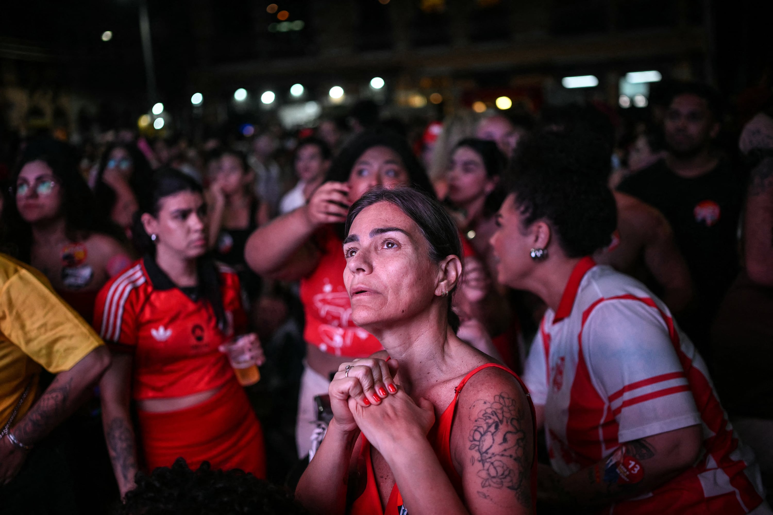 A supporter of Brazil's President and presidential candidate Luiz Inacio Lula da Silva reacts following the first results of the presidential election in Rio Janeiro