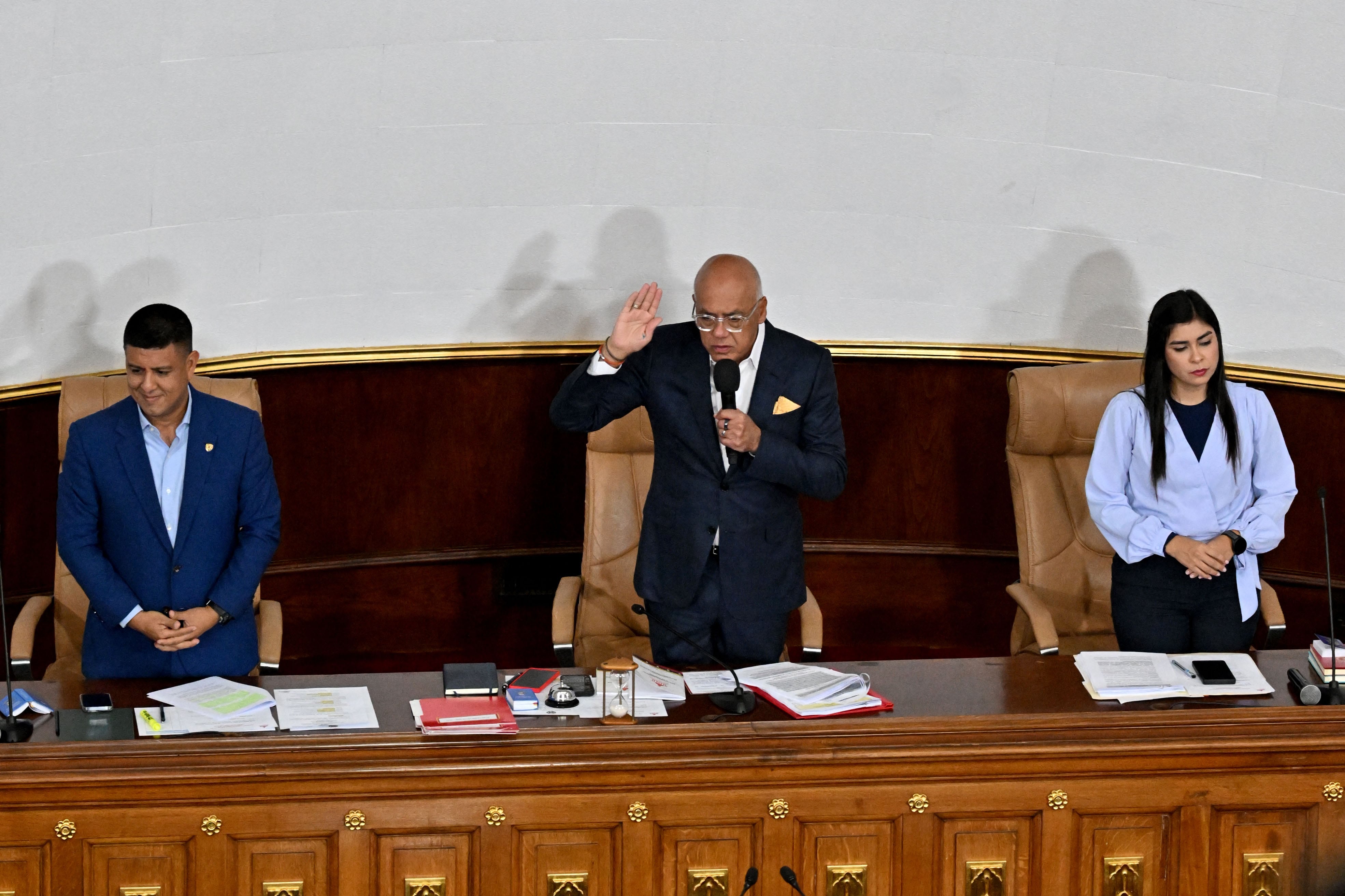 Venezuela's President of the National Assembly Jorge Rodriguez (C) swears in substitute lawmakers before a plenary session at the National Assembly in Caracas on January 22, 2026. Venezuela's parliament on January 22 begins debating plans to throw open the country's lucrative oil sector to private investment, less than three weeks after the US ouster of Nicolas Maduro. (Photo by Juan BARRETO / AFP)