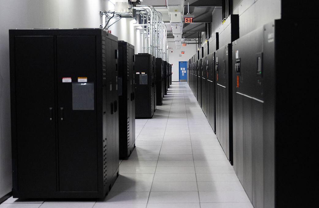 Power banks on the left, and active servers are seen at a Digital Realty data center in Ashburn, Virginia on November 12, 2025. (Photo by ANDREW CABALLERO-REYNOLDS / AFP)