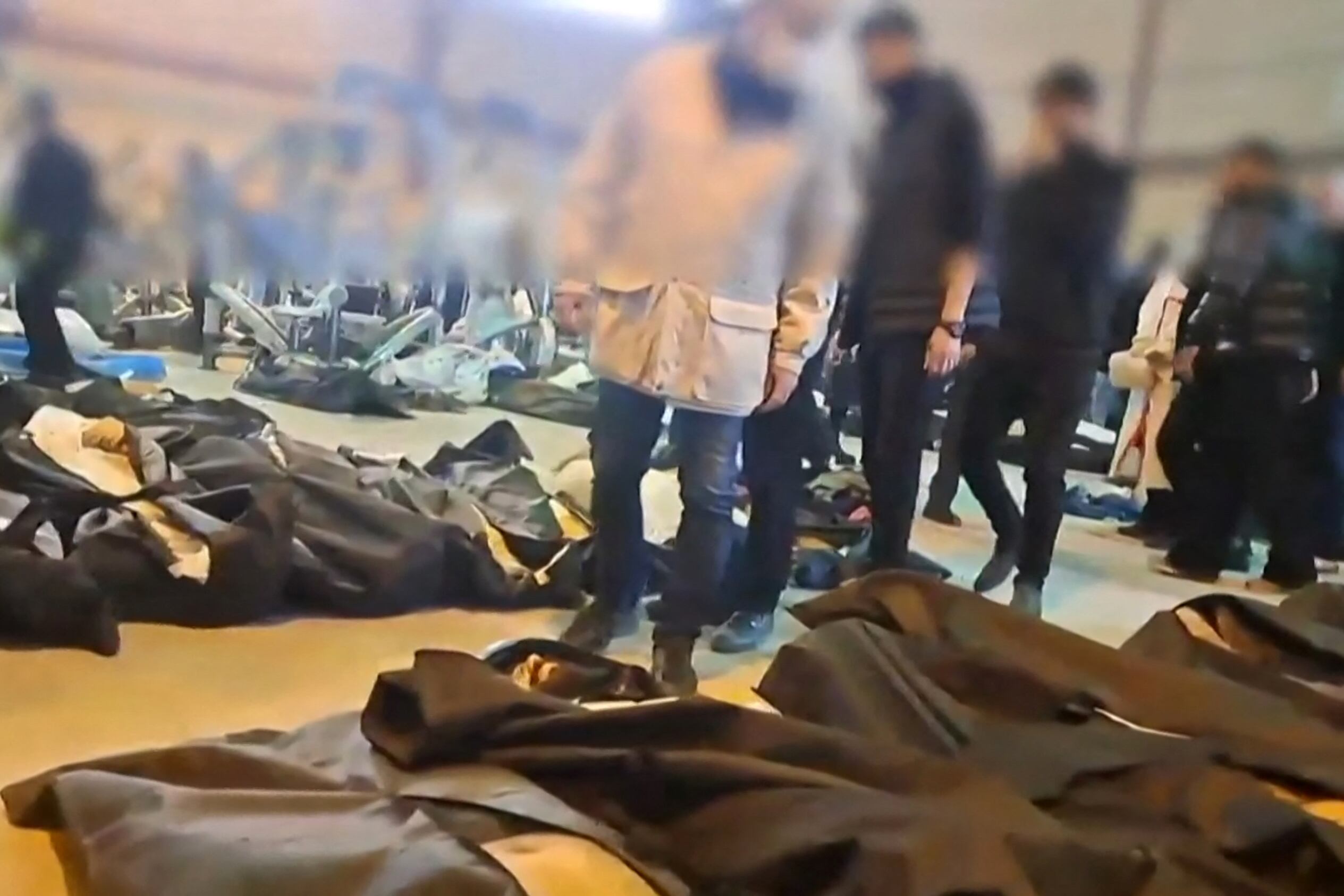 EDITORS NOTE: Graphic content / This video grab taken on January 13, 2026 from UGC images posted on social media on January 12, 2026 shows dozens of bodies lying inside the Tehran Province Forensic Diagnostic and Laboratory Centre in Kahrizak, with what appeares to be grieving relatives searching for loved ones. Other videos showing the same scenes first appeared online on January 10, 2026.
A violent crackdown on a wave of protests in Iran has killed at least 648 people, a rights group said on January 12, 2026, as Iranian authorities sought to regain control of the streets with mass nationwide rallies. (Photo by UGC / AFP) / Israel OUT / NO USE AFTER JANUARY 22, 2026 07:47:24 GMT - ISRAEL OUT / NO USE AFTER JANUARY 22, 2026 07:47:24 GMT - ISRAEL OUT / RESTRICTED TO EDITORIAL USE - MANDATORY CREDIT AFP -  SOURCE: ANONYMOUS - NO MARKETING - NO ADVERTISING CAMPAIGNS  - DISTRIBUTED AS A SERVICE TO CLIENTS - NO RESALE - NO ARCHIVE - NO ACCESS ISRAEL MEDIA/PERSIAN LANGUAGE TV STATIONS OUTSIDE IRAN/ STRICTLY NO ACCESS BBC PERSIAN/ VOA PERSIAN/ MANOTO-1 TV/ IRAN INTERNATIONAL/RADIO FARDA - AFP IS NOT RESPONSIBLE FOR ANY DIGITAL ALTERATIONS TO THE PICTURE'S EDITORIAL CONTENT /