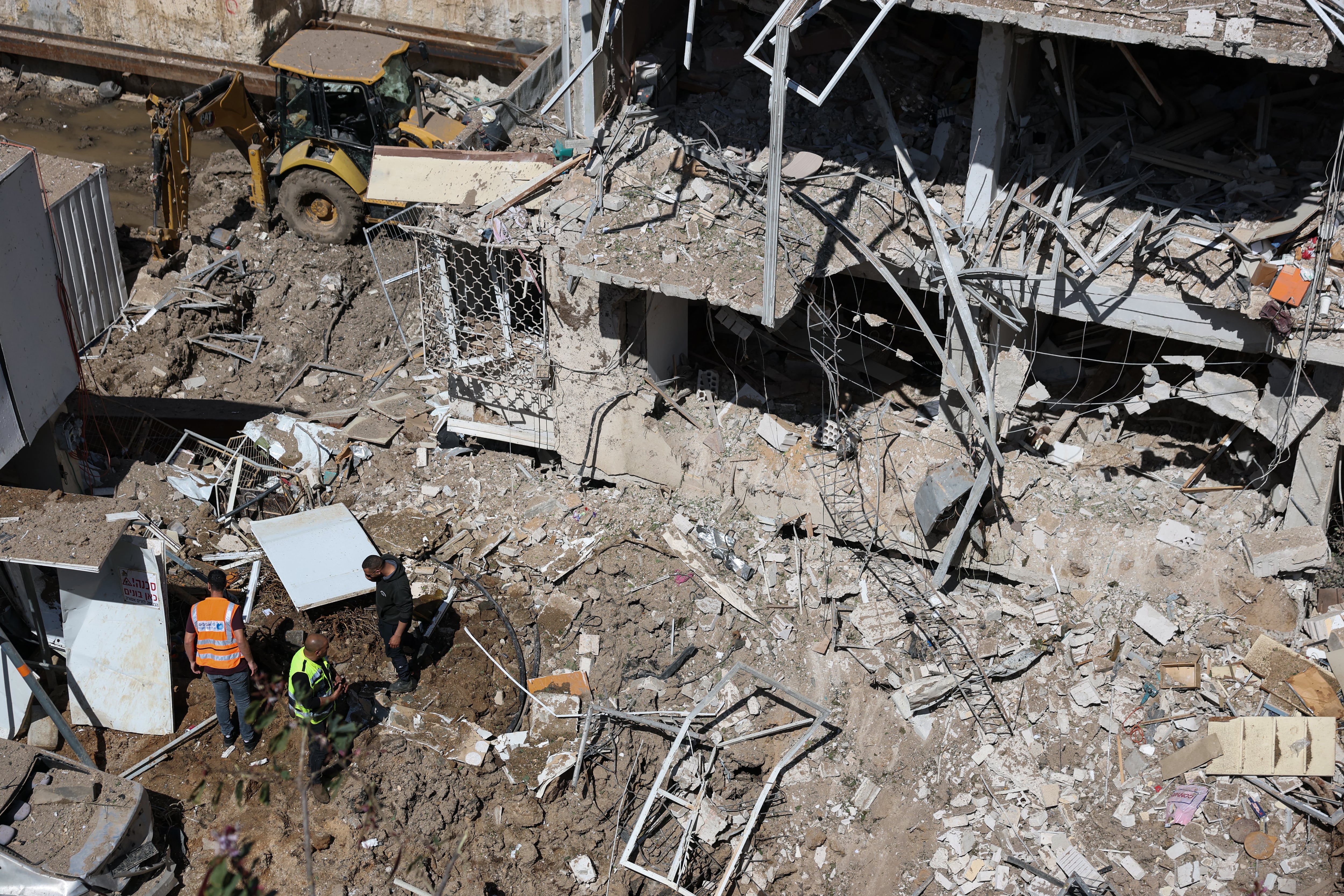 Israeli emergency service personnel gather at the site of an Iranian missile strike in Tel Aviv on March 24, 2026.
Iran fired a fresh broadside of missiles at Israel March 24, causing damage and injuries in Tel Aviv, as uncertainty swirled over possible talks to end the three-week Middle East war.