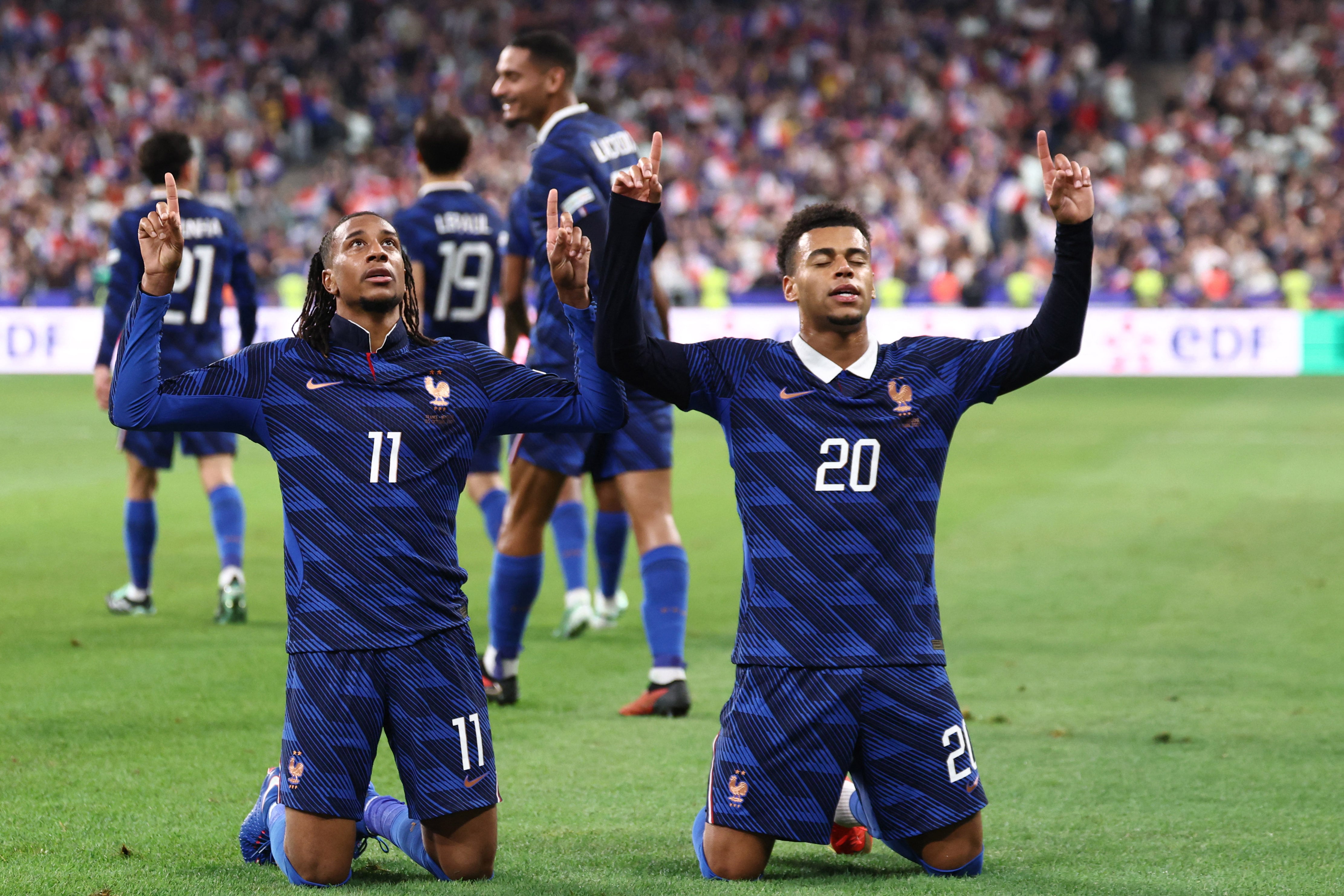 France's midfielder #11 Michael Olise (L) celebrates with France's forward #20 Desire Doue after scoring his team's fourth goal during the UEFA Nations League Group A1 football match between France and Belgium at the Stade de France in Saint-Denis, north of Paris, on October 5, 2026. (Photo by FRANCK FIFE / AFP)