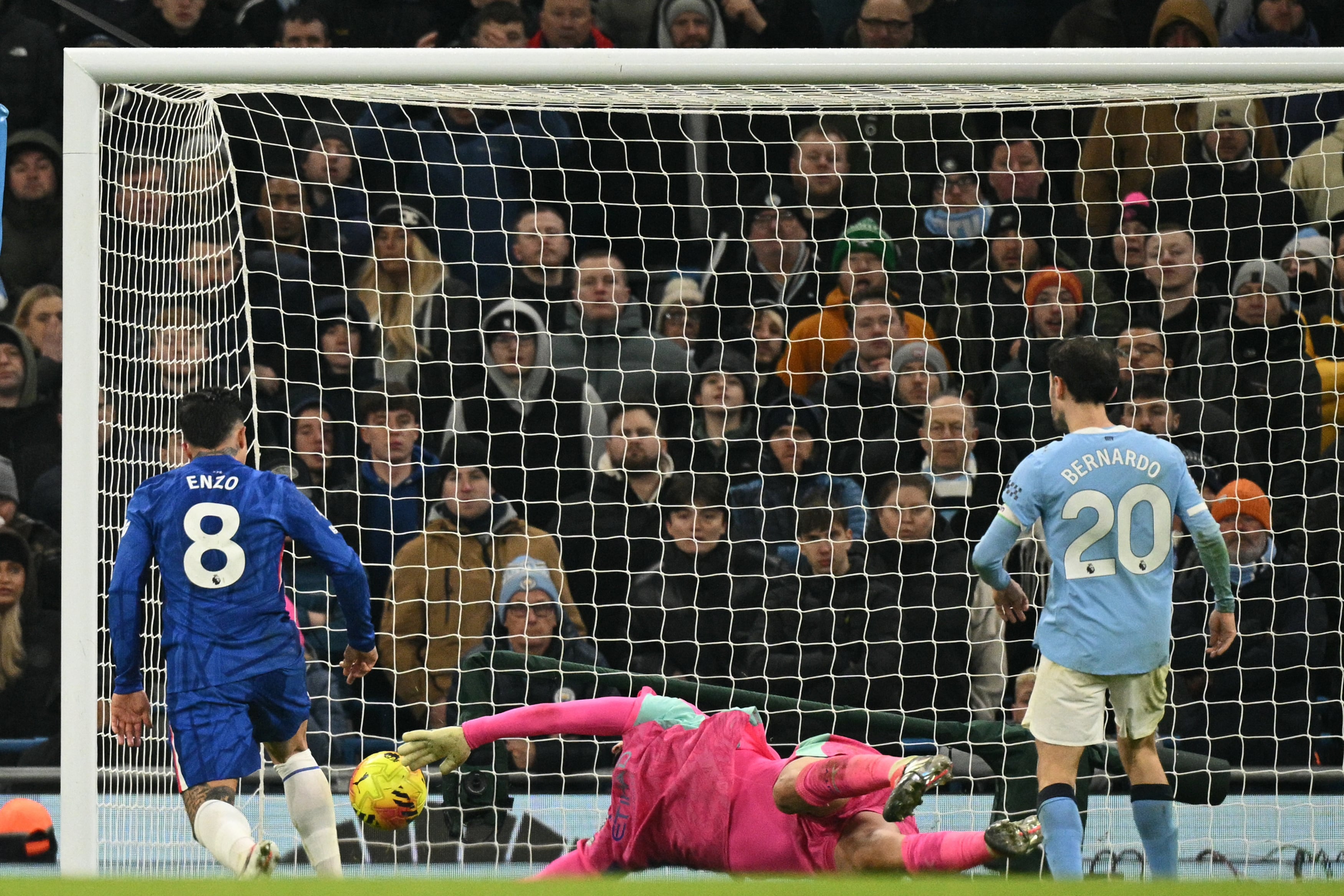 Manchester City's Italian goalkeeper #25 Gianluigi Donnarumma makes a save as Chelsea's Argentinian midfielder #08 Enzo Fernandez prepares to score during the English Premier League football match between Manchester City and Chelsea at the Etihad Stadium in Manchester, north west England, on January 4, 2026. (Photo by Oli SCARFF / AFP) / RESTRICTED TO EDITORIAL USE. NO USE WITH UNAUTHORIZED AUDIO, VIDEO, DATA, FIXTURE LISTS, CLUB/LEAGUE LOGOS OR 'LIVE' SERVICES. ONLINE IN-MATCH USE LIMITED TO 120 IMAGES. AN ADDITIONAL 40 IMAGES MAY BE USED IN EXTRA TIME. NO VIDEO EMULATION. SOCIAL MEDIA IN-MATCH USE LIMITED TO 120 IMAGES. AN ADDITIONAL 40 IMAGES MAY BE USED IN EXTRA TIME. NO USE IN BETTING PUBLICATIONS, GAMES OR SINGLE CLUB/LEAGUE/PLAYER PUBLICATIONS. /