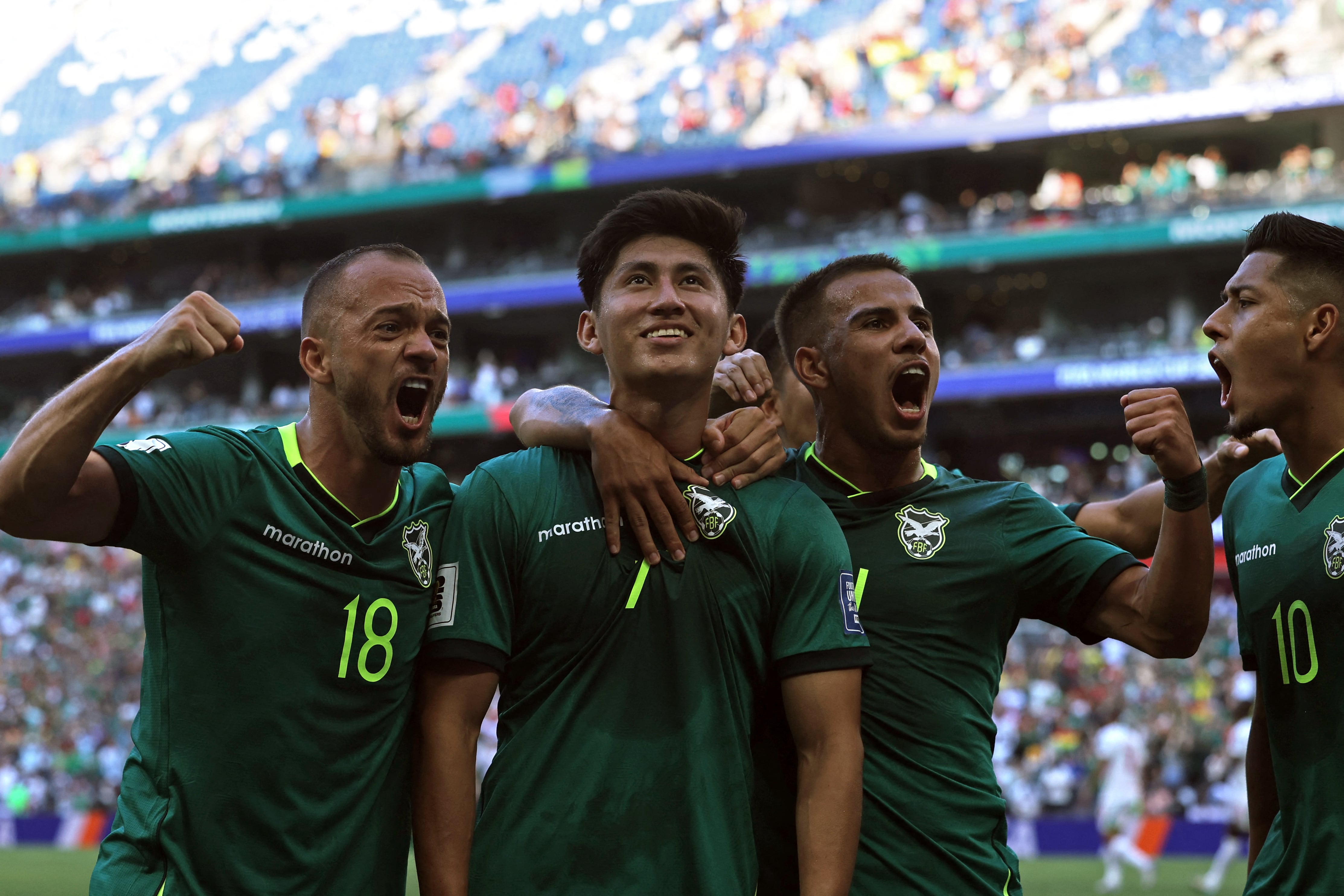 Bolivia's forward #07 Miguel Terceros (2nd L) celebrates with teammates midfielder #18 Juan Godoy (L), midfielder #14 Robson Matheus and forward #10 Ramiro Vaca after scoring a penalty kick during the 2026 FIFA World Cup qualifiers semi-final playoff football match between Bolivia and Suriname at the BBVA Stadium in Guadalupe, Mexico on March 26, 2026. (Photo by Julio Cesar AGUILAR / AFP)