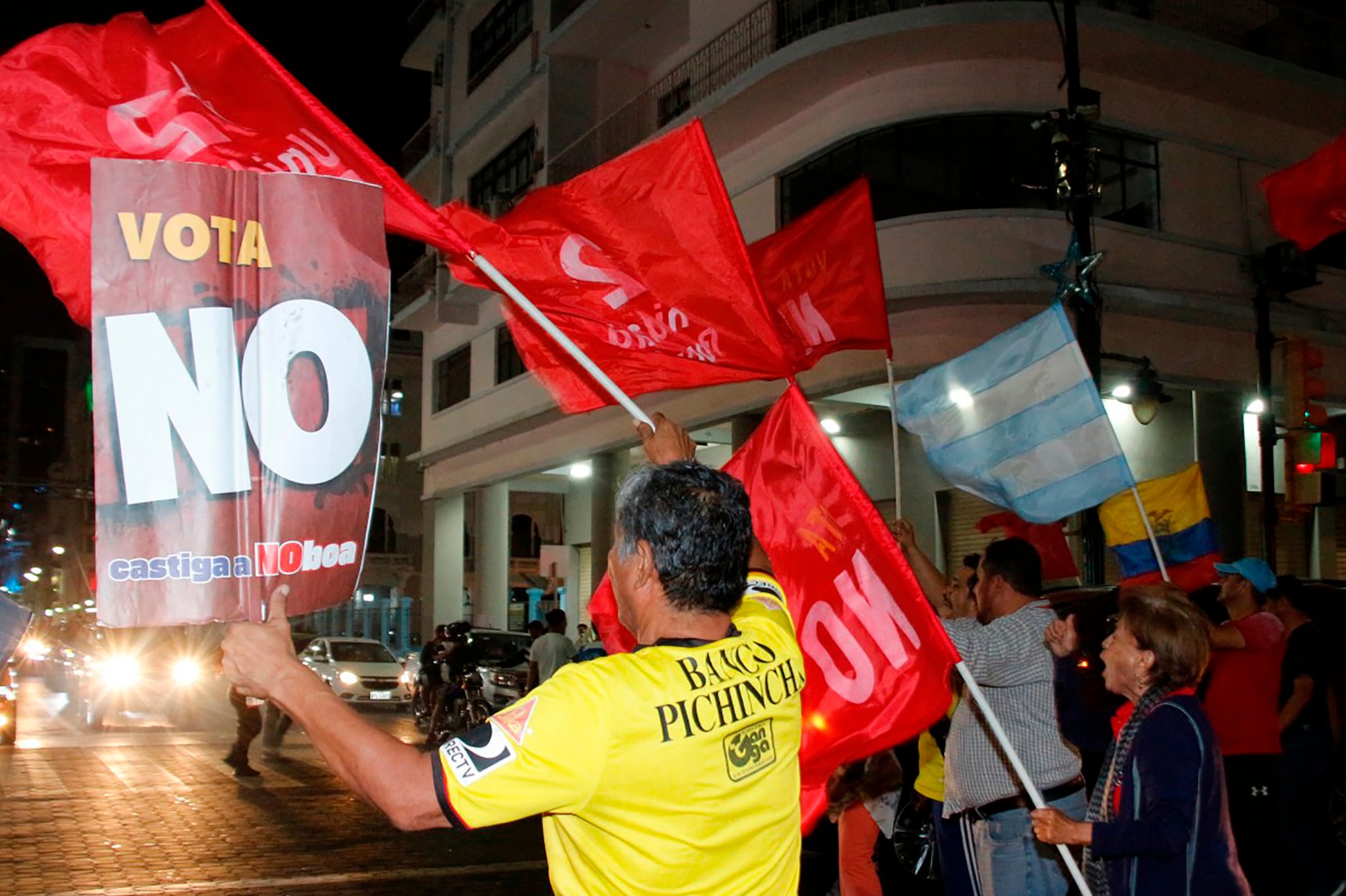 People celebrate following the first results of the constitutional reform referendum in Guayaquil, Ecuador on November 16, 2025. Ecuadoran voters appeared poised on November 16, 2025, to reject the return of US military bases, according to early referendum results, a damaging blow to Trump-friendly President Daniel Noboa. (Photo by Gerardo MENOSCAL / AFP)
