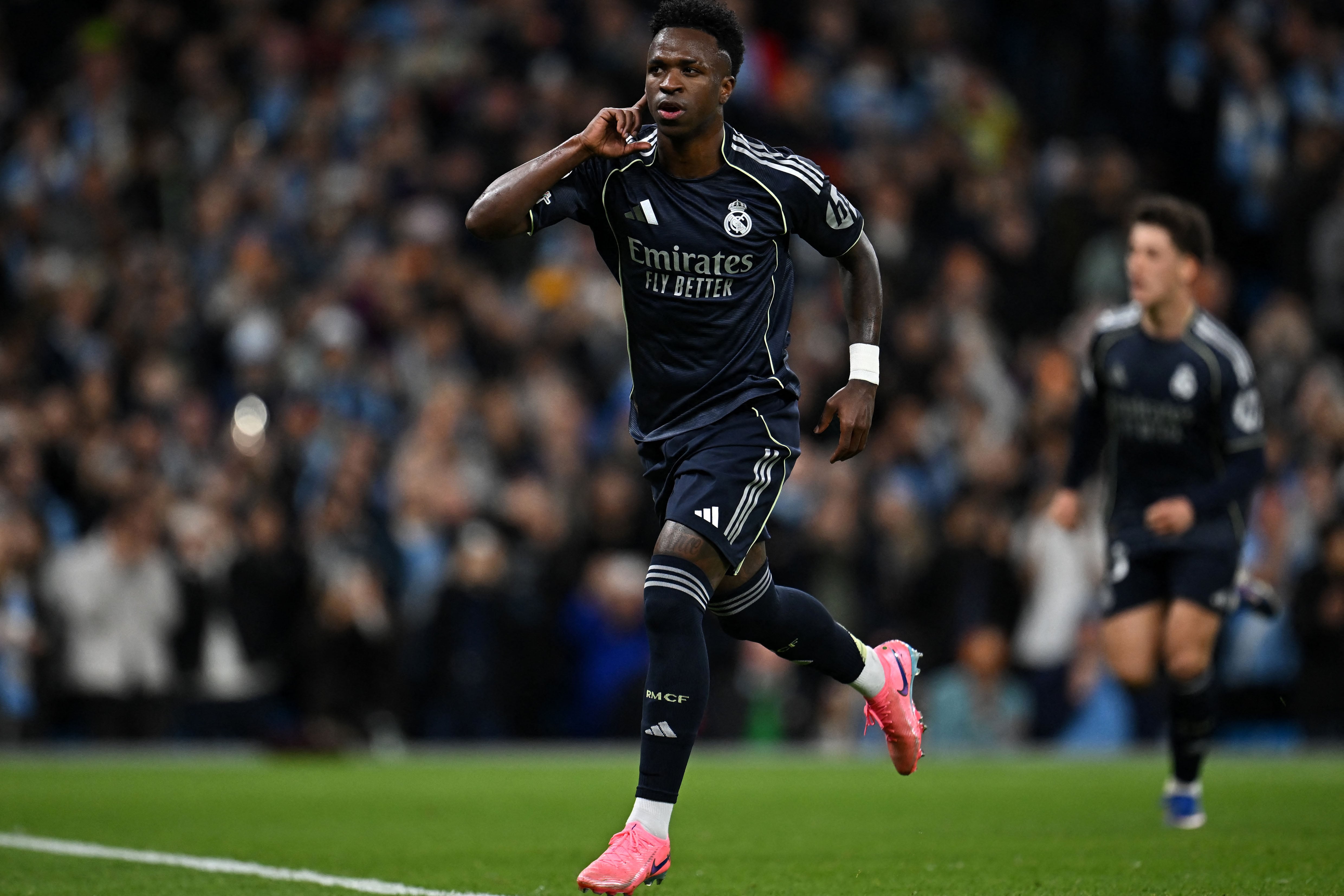 Real Madrid's Brazilian forward #07 Vinicius Junior celebrates scoring the opening goal during the UEFA Champions League, round of 16 second leg football match between Manchester City and Real Madrid at the Etihad Stadium in Manchester, north west England, on March 17, 2026. (Photo by Paul ELLIS / AFP)