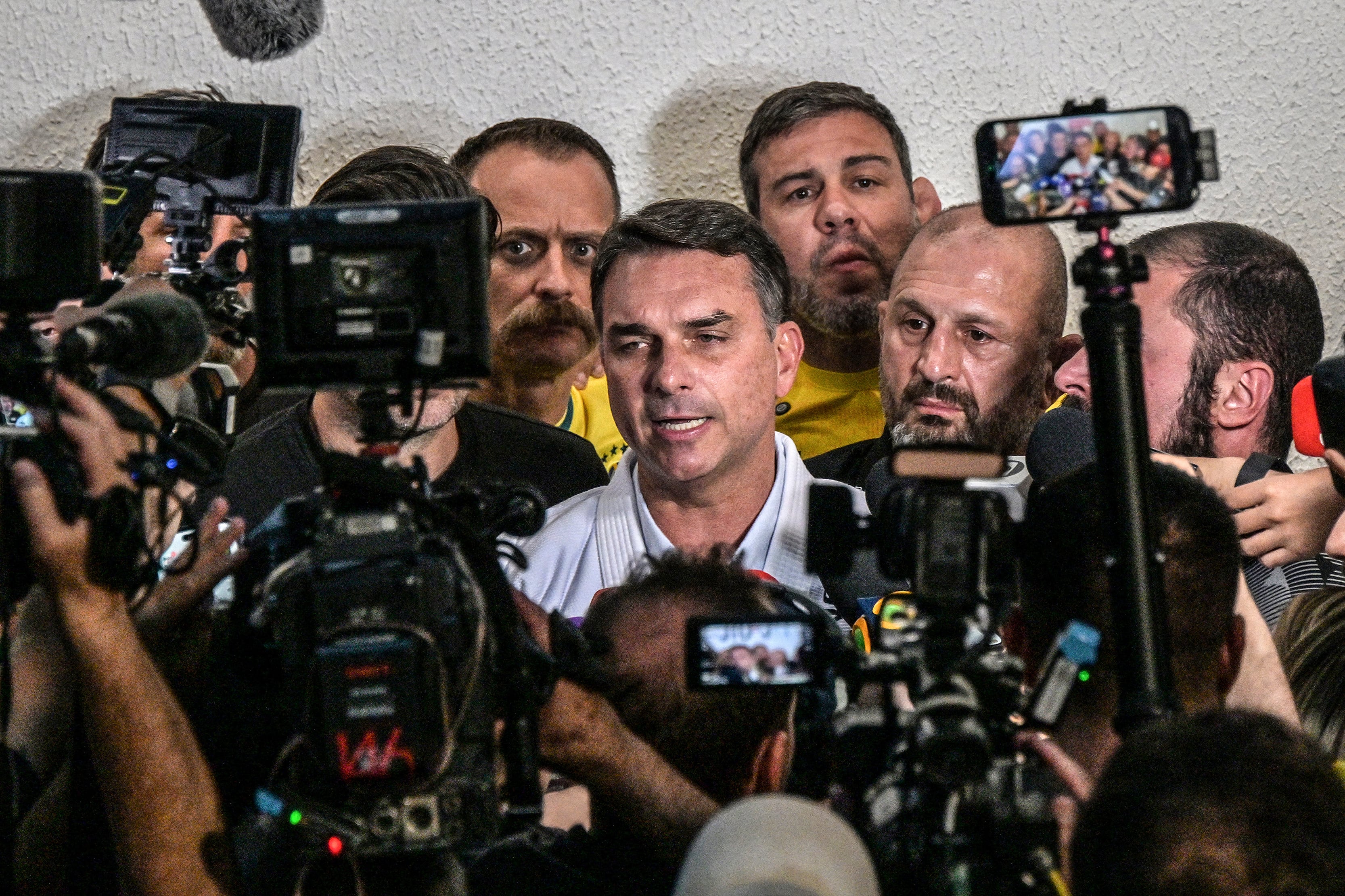 Brazil's right-wing senator and presidential candidate Flavio Bolsonaro of the Liberal Party (PL) speaks with journalists