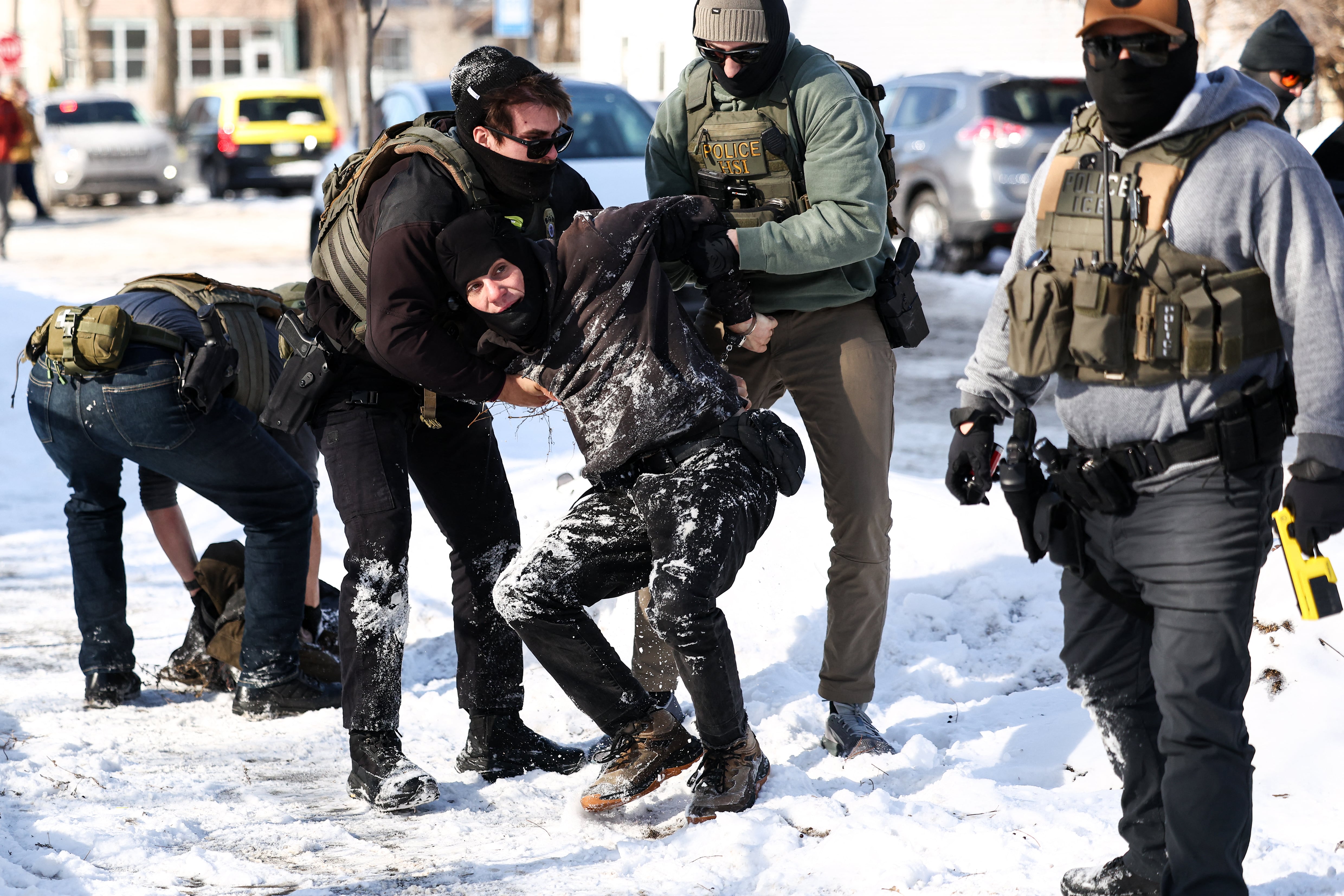 Federal agents detain a protester in Minneapolis, Minnesota on February 3, 2026. A US judge on January 31, 2026 denied Minnesota's bid to force Immigration and Customs Enforcement (ICE) to suspend its sweeping detention and deportation operation in the state that has left two US citizens dead and fueled massive protests. Masked and heavily armed federal agents have swept through Minnesota communities seeking undocumented migrants, detaining thousands and shooting dead two US citizens in the process. (Photo by Charly TRIBALLEAU / AFP)