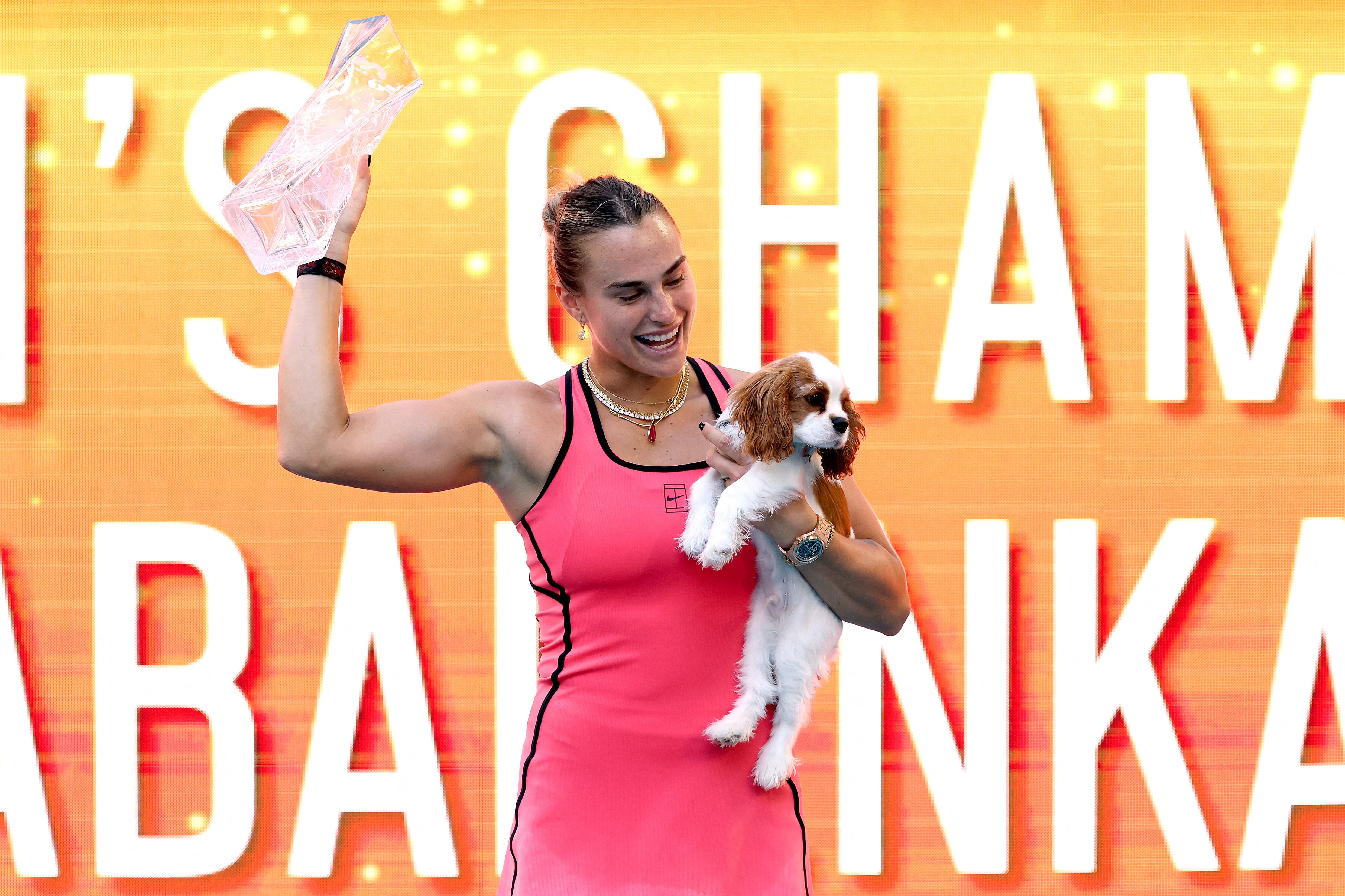 MIAMI GARDENS, FLORIDA - MARCH 28: Aryna Sabalenka celebrates with the Butch Buchholz trophy and her dog Ash after defeating Coco Gauff of the United States during the Women's Singles Final on Day 12 of the Miami Open Presented by Itau at Hard Rock Stadium on March 28, 2026 in Miami Gardens, Florida.   Matthew Stockman/Getty Images/AFP (Photo by MATTHEW STOCKMAN / GETTY IMAGES NORTH AMERICA / Getty Images via AFP)