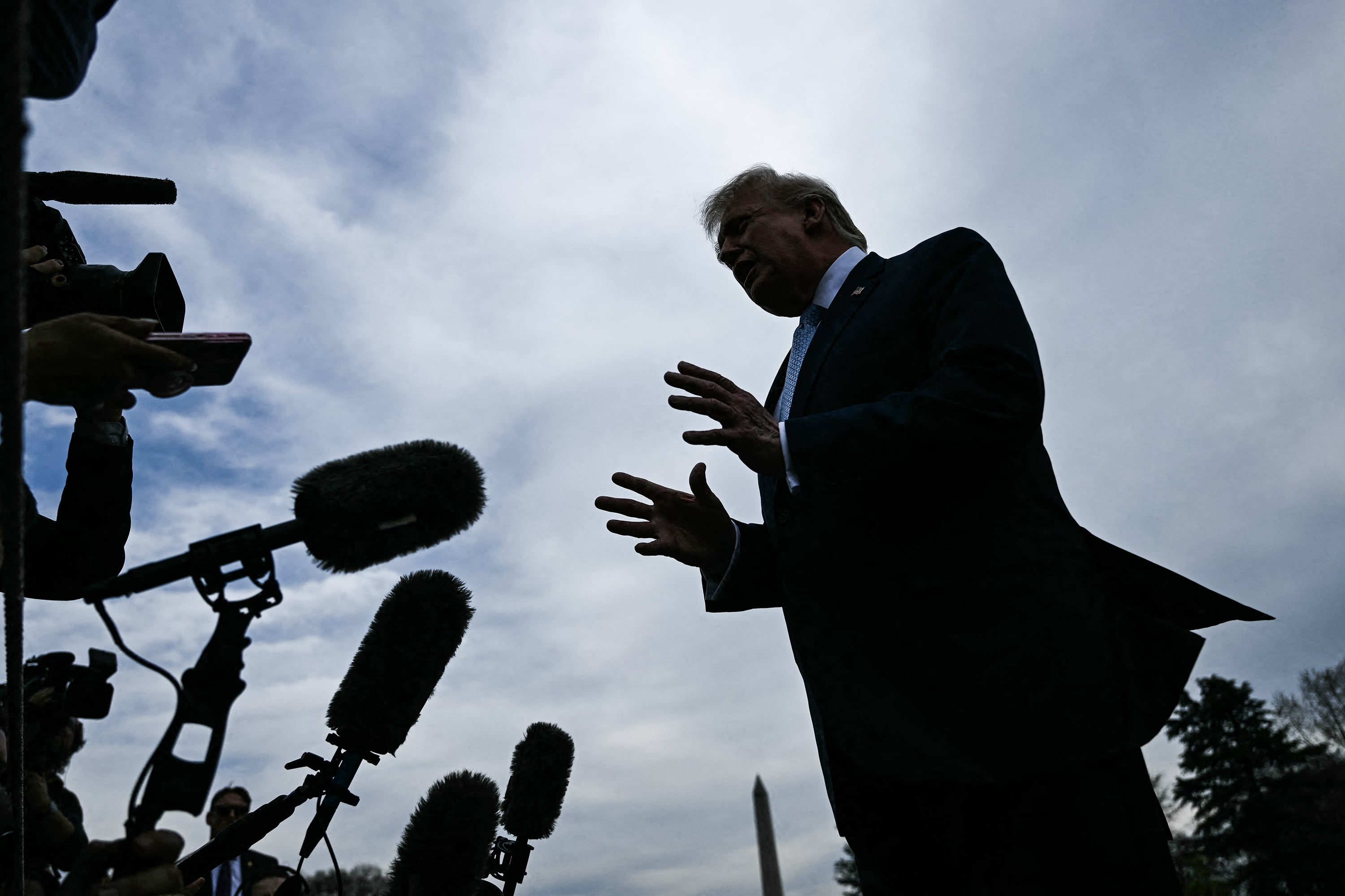 US President Donald Trump speaks to journalists before boarding Marine One as he departs from the South Lawn of the White House in Washington, DC,