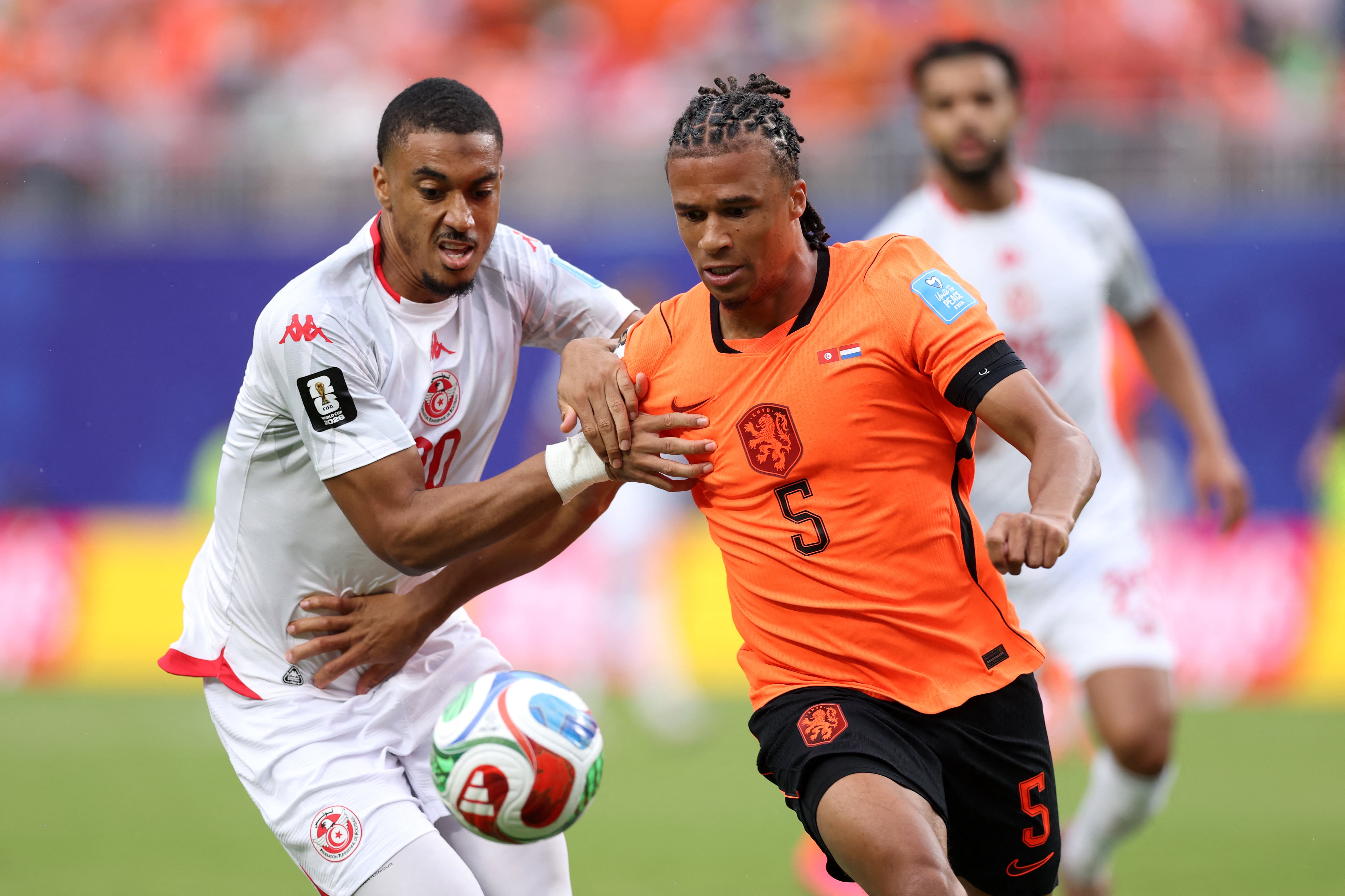 KANSAS CITY, MISSOURI - JUNE 25: Nathan Ake #5 of Netherlands is challenged by Yan Valery #20 of Tunisia during the FIFA World Cup 2026 Group F match between Tunisia and Netherlands at Kansas City Stadium on June 25, 2026 in Kansas City, Missouri.   Michael Steele/Getty Images/AFP (Photo by MICHAEL STEELE / GETTY IMAGES NORTH AMERICA / Getty Images via AFP)