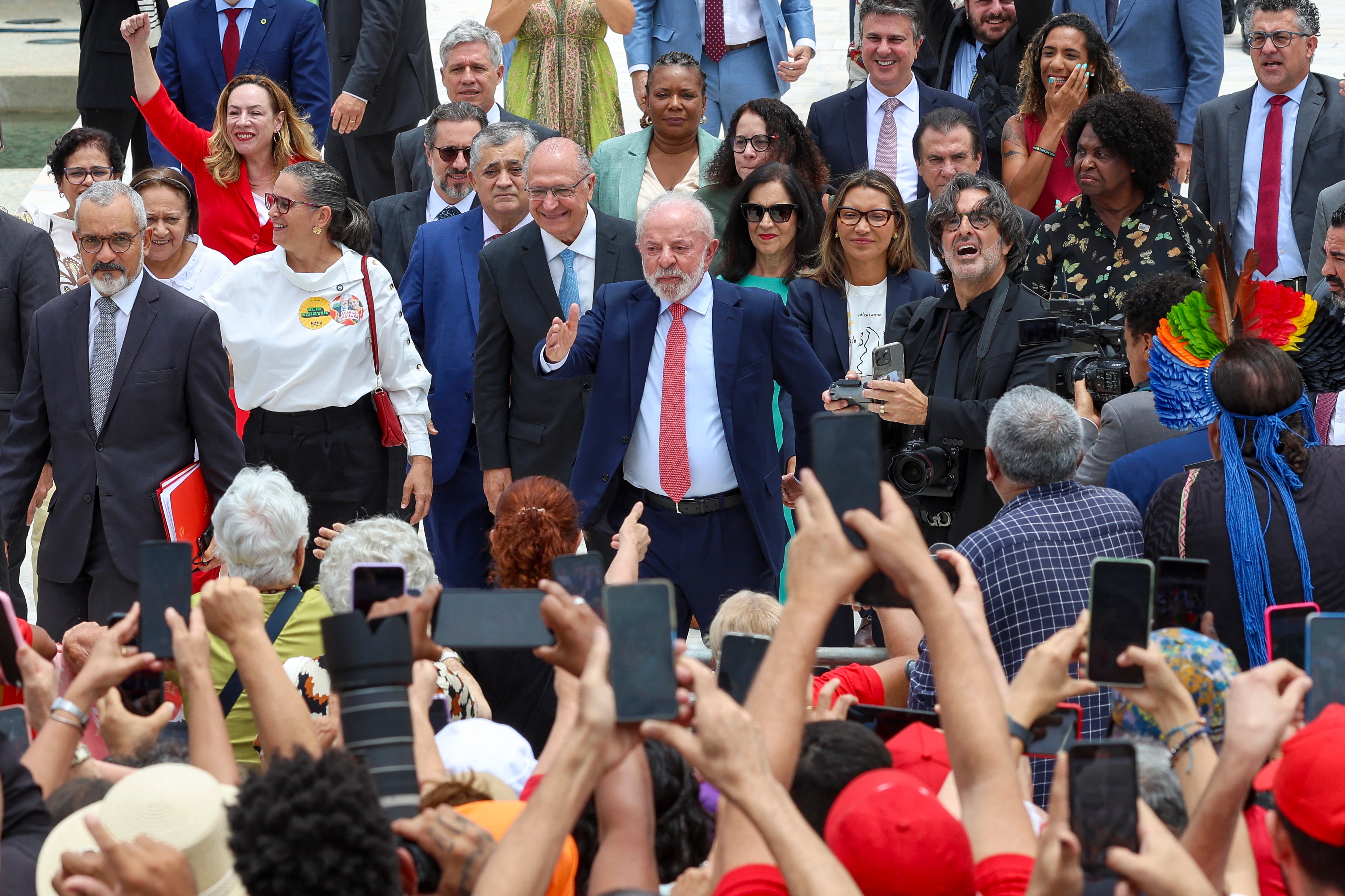 Brazil�s President Luiz Inacio Lula da Silva greets supporters next to First Lady Rosangela 'Janja' Da Silva during the Ceremony in Defense of Democracy marking the third anniversary of the attempted coup d'�tat involving the invasion and destruction of buildings of the three branches of government, at the Planalto Palace in Bras�lia, on January 8, 2026. (Photo by Sergio Lima / AFP)